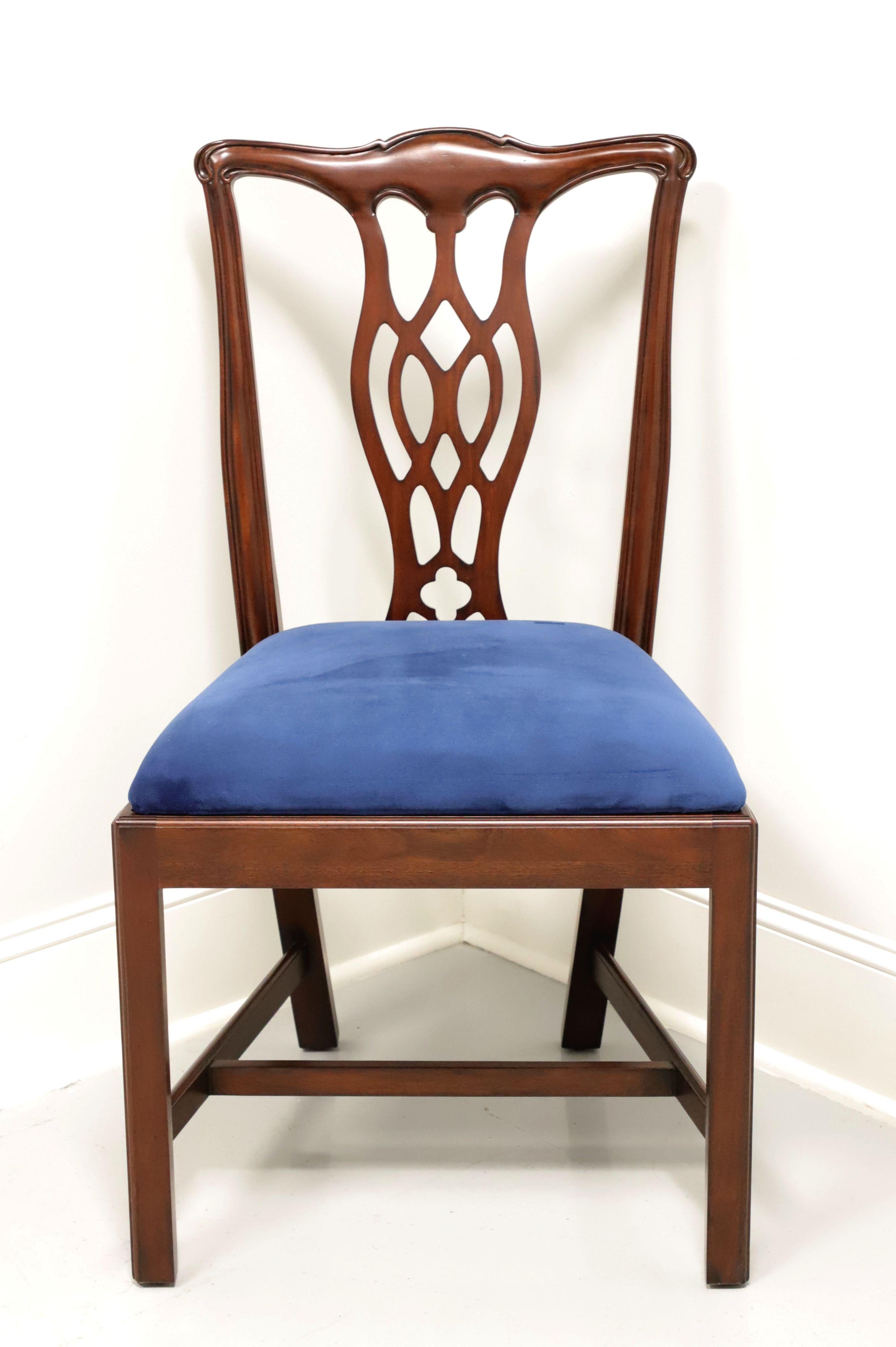 A dining side chair in the Chippendale style by Hickory Chair Company. Solid mahogany with carved crestrail, carved seat back, blue color crushed velvet upholstered seat, straight legs and stretchers. Made in North Carolina, USA, in the late 20th