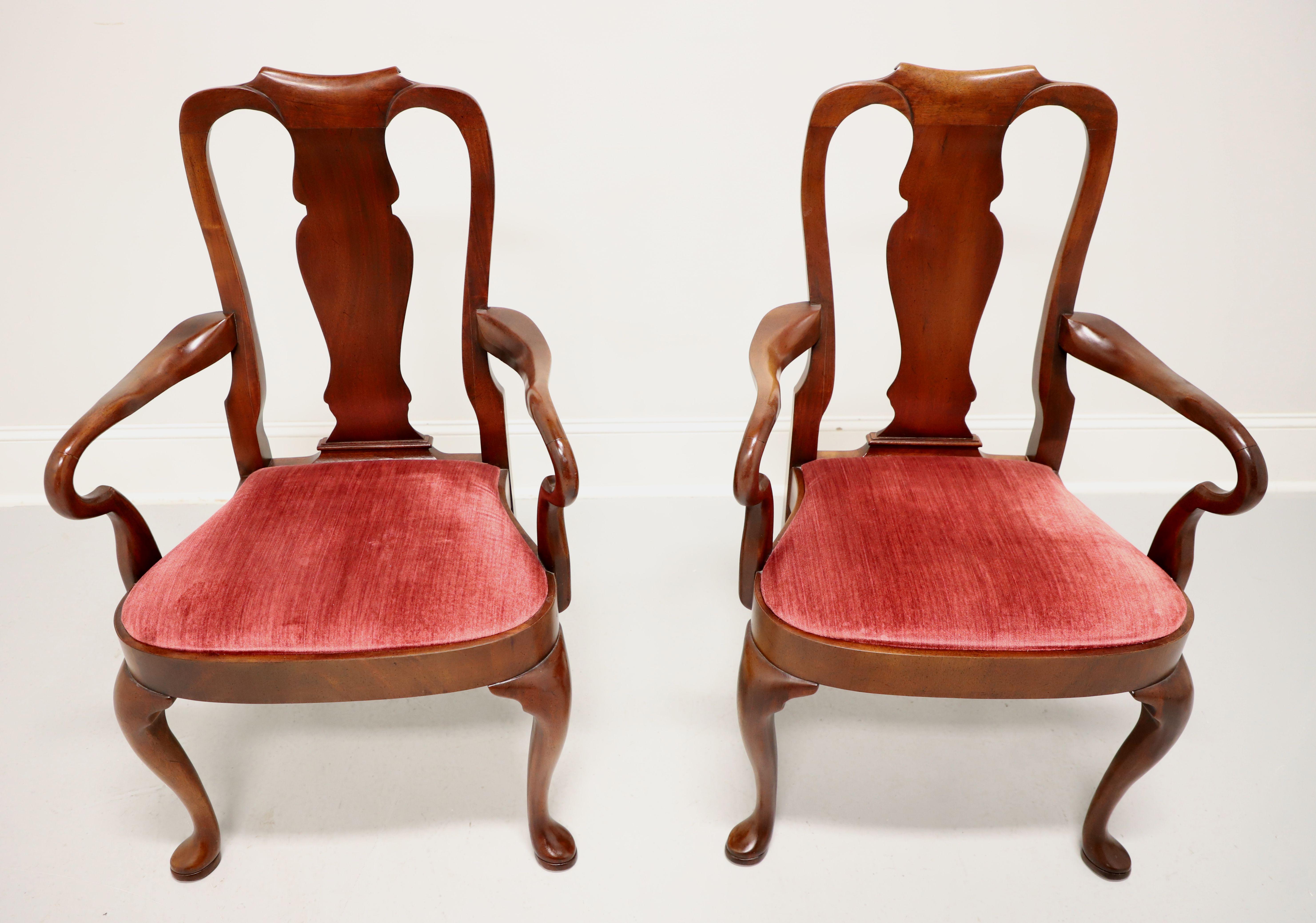 A pair of Queen Anne style dining armchairs by high-quality furniture maker Hickory Chair. Mahogany with solid carved back rest, curved arms & supports, a rose red color velvet fabric upholstered seat, rounded apron, cabriole legs and pad feet. Made