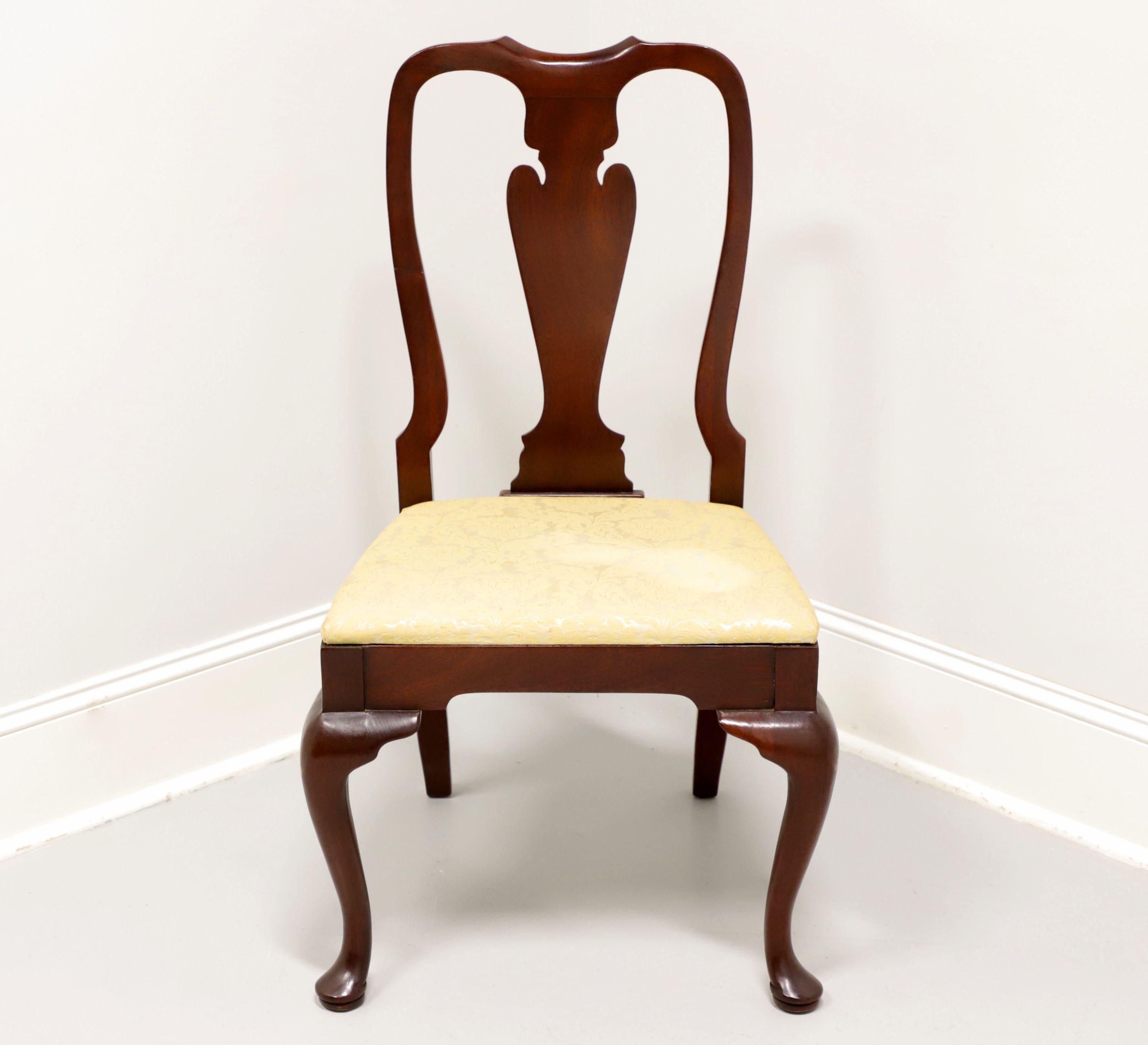 A Queen Anne style dining side chair by Hickory Chair. Mahogany with solid carved back, a creamy yellow fabric upholstered seat, cabriole legs and pad feet. Made in North Carolina, USA, in the late 20th century.

Measures: Overall: 22.25w 23.5d