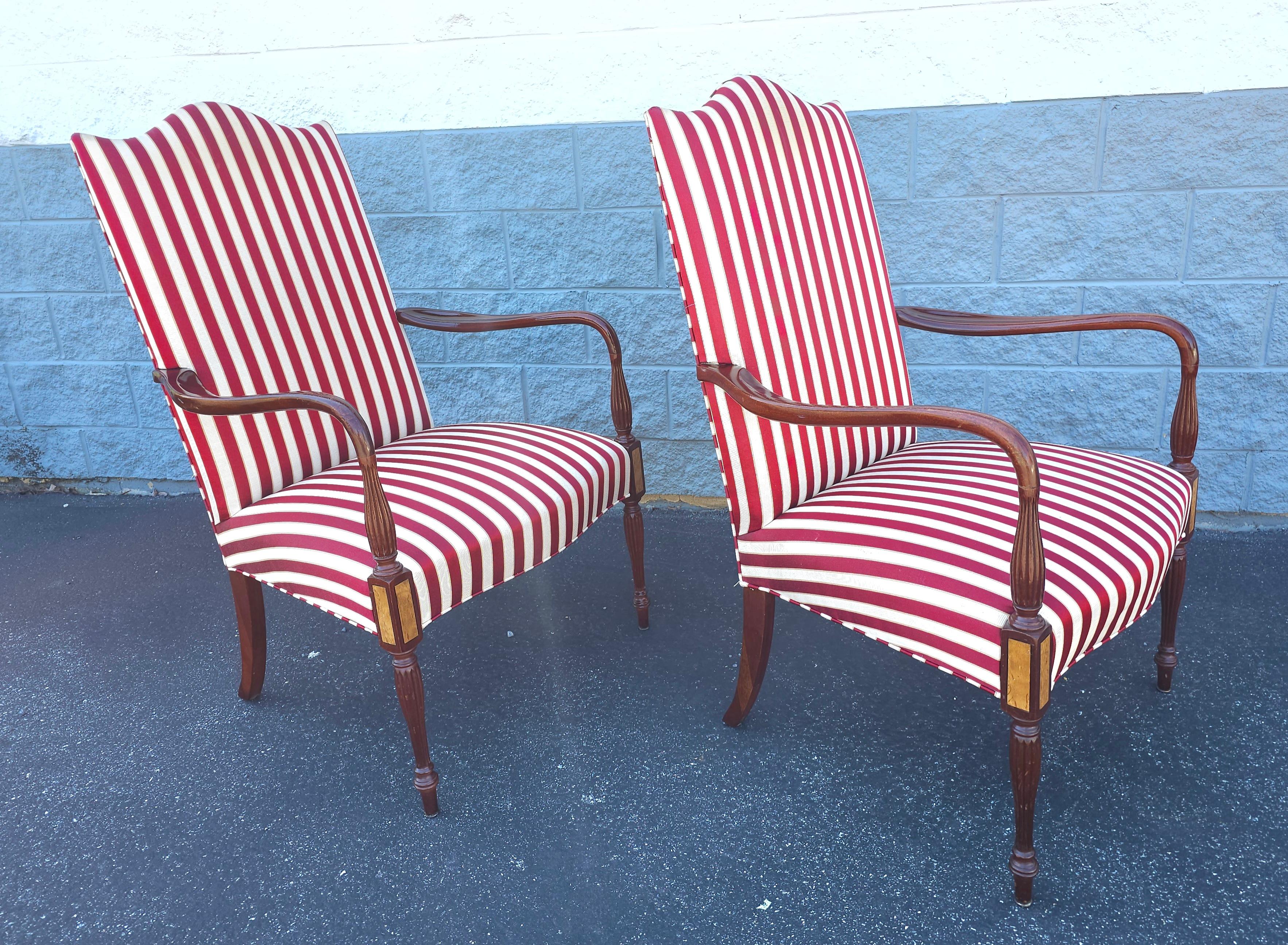 A pair of Late 20th Century Hickory Chair Furniture Sheraton Style Mahogany Upholstered Open Arm Lolling Martha Washington Armchairs, with the James River Collection stripped Upholstery. Measures 27.25
