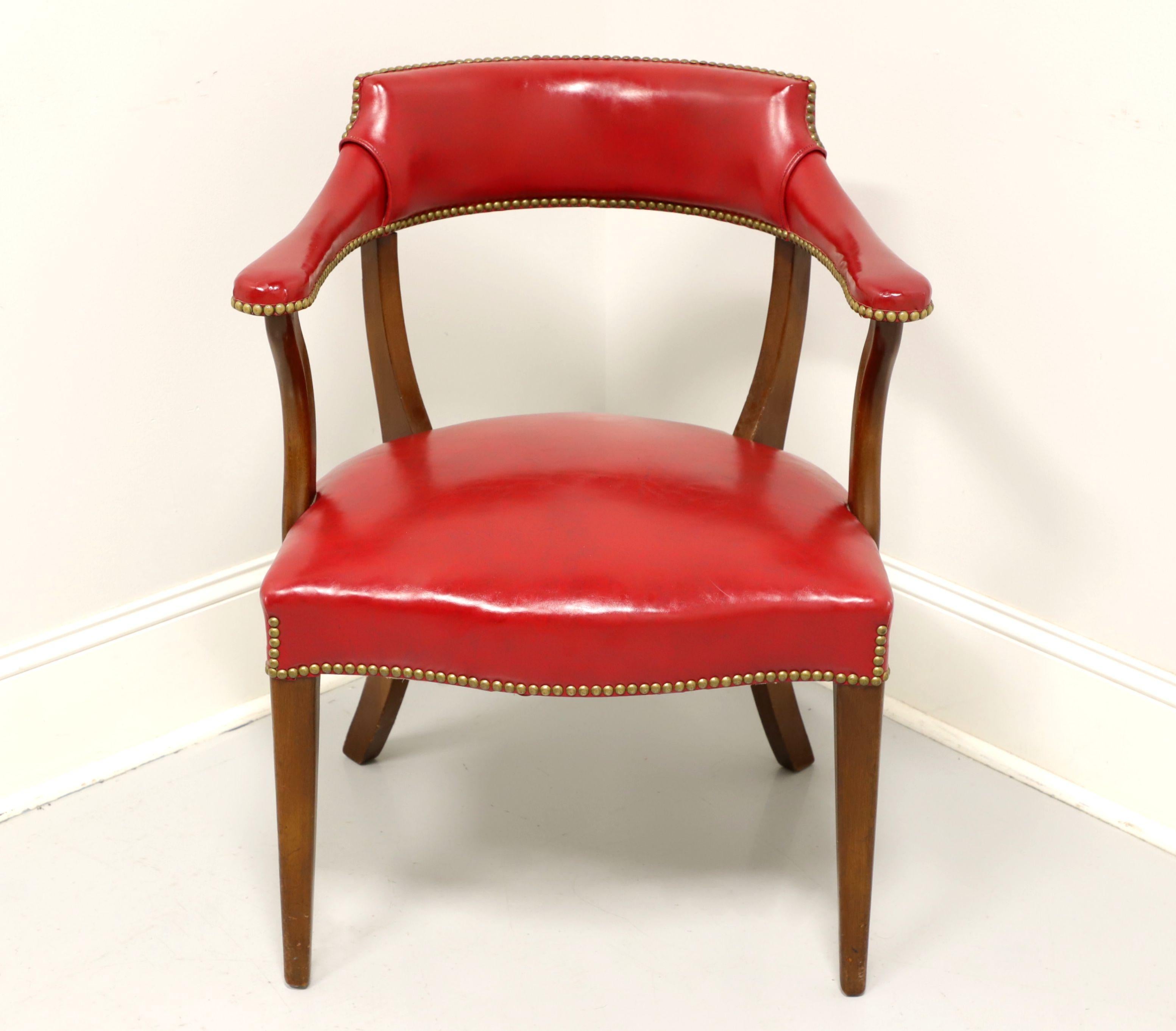A vintage Traditional style library / office chair by Hickory Chair Company, of Hickory, North Carolina, USA. Solid mahogany frame with red faux leather (vinyl) upholstery, brass nailhead trim, saber rear legs and tapered straight front legs. Made