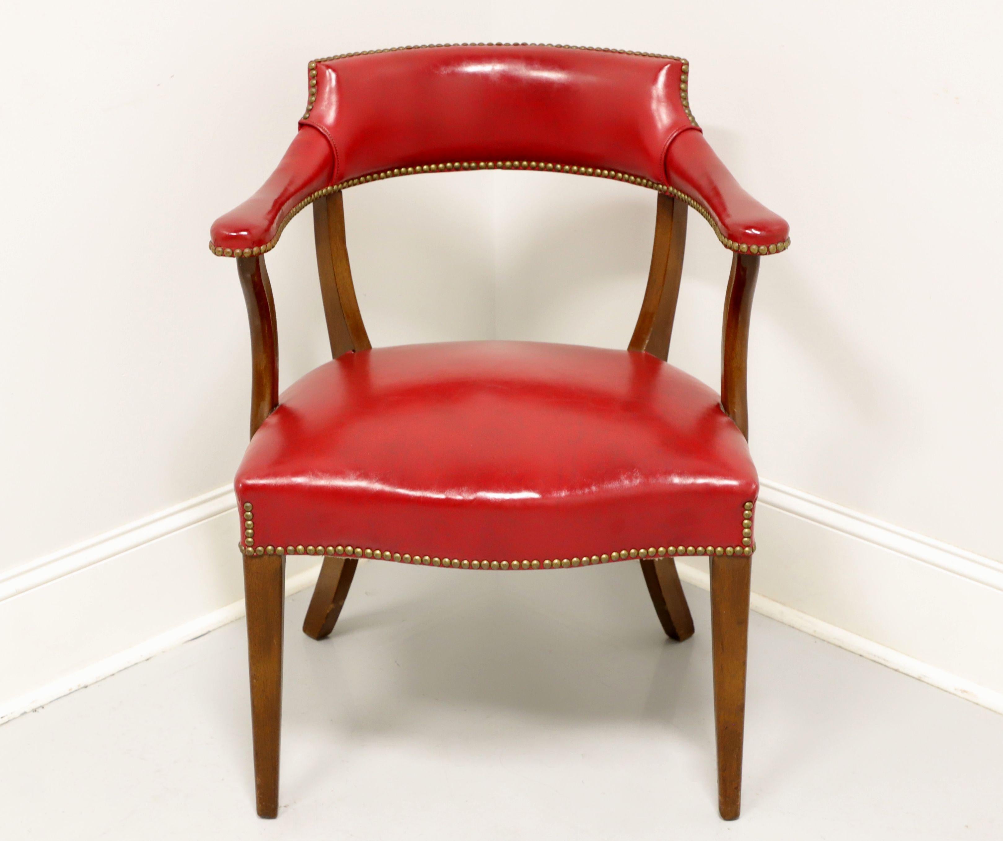 A vintage Traditional style library / office chair by Hickory Chair Company, of Hickory, North Carolina, USA. Solid mahogany frame with red faux leather (vinyl) upholstery, brass nailhead trim, saber rear legs and tapered straight front legs. Made