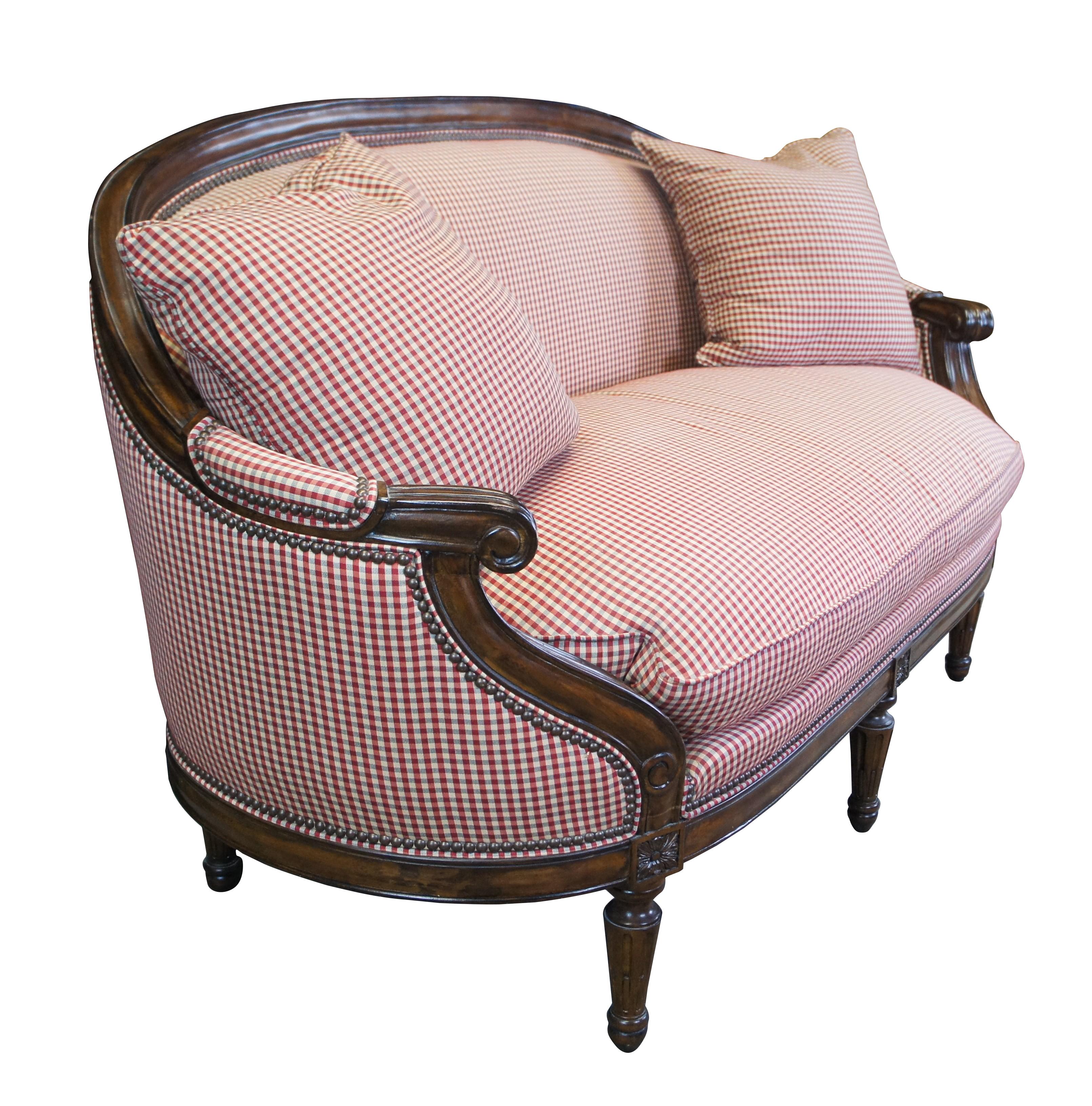 Vintage Hickory Chair company Park Avenue parlor settee / love seat / bench.  Made of mahogany featuring round form with padded arm, red plaid upholstery, nailhead trim, floral carved accents and tapered fluted legs.

Dimensions:
67