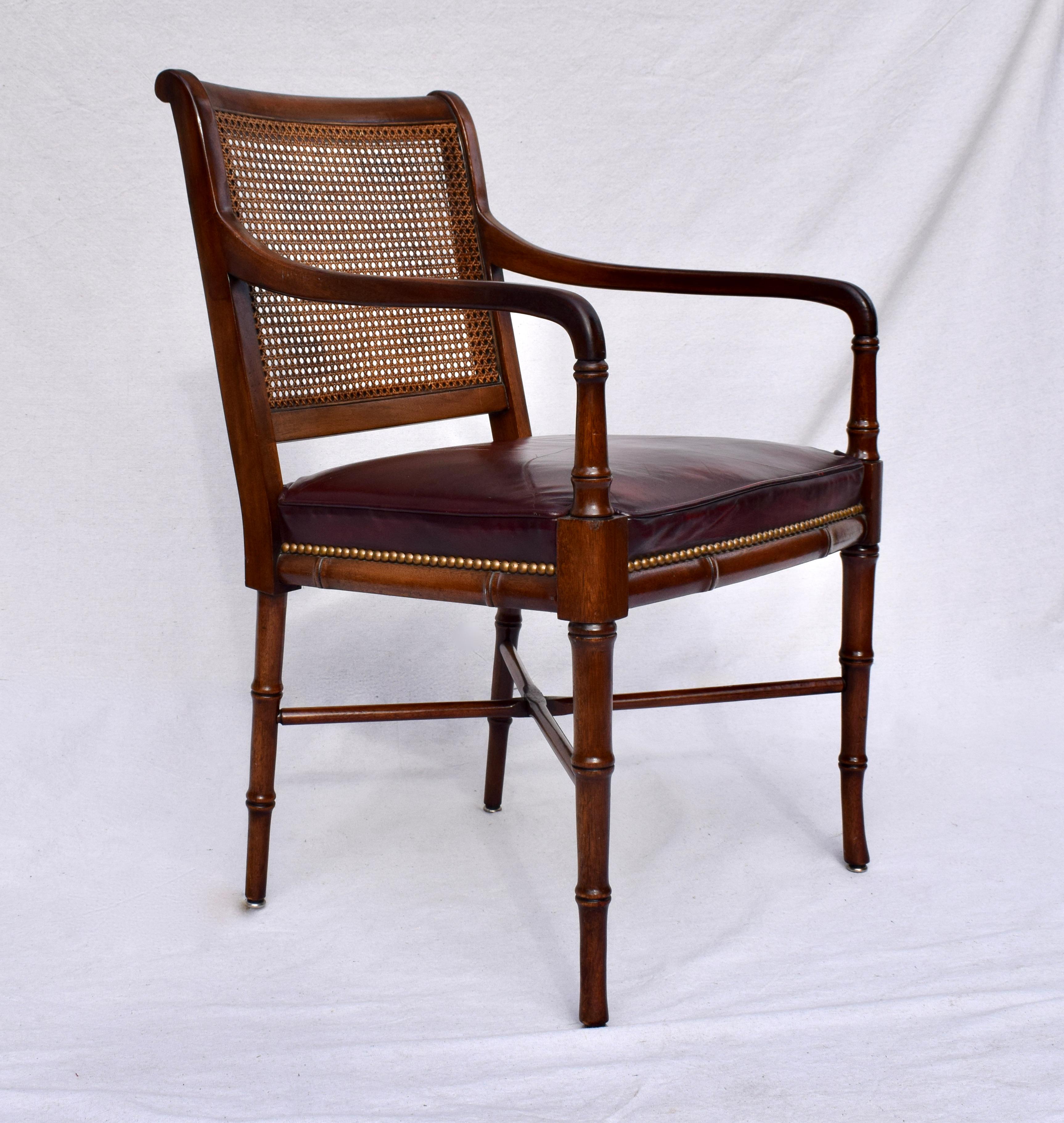Regency style arm chair by Hickory Chair. Features include caned back, leather seat with brass tacks, X base stretcher & solid Mahogany faux bamboo frame. Suitable for desk, dining and occasional uses.