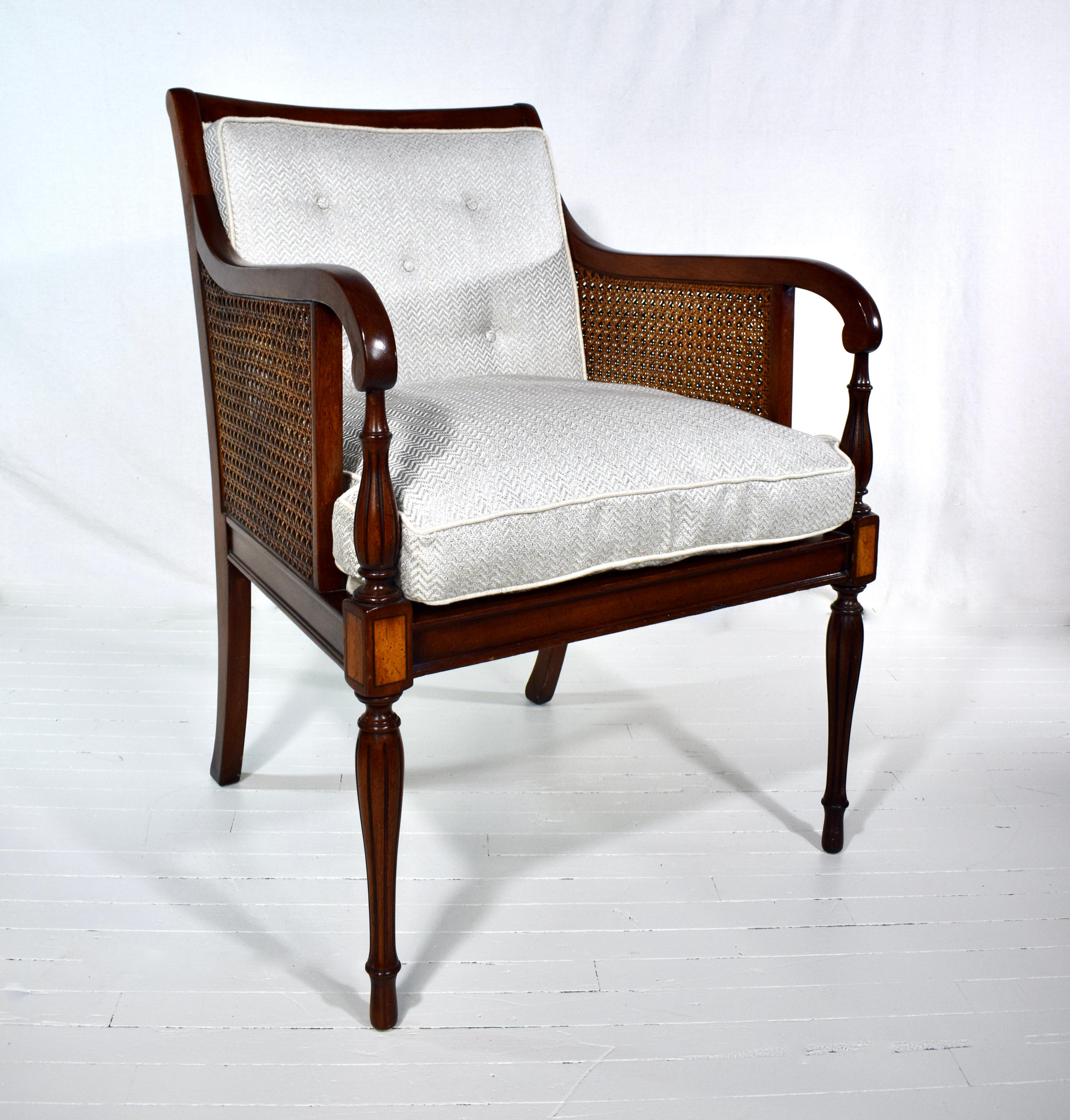 A double caned, George III Regency style mahogany & satinwood armchair with tapered reed & turned legs. The chair is fully hand detailed with beautifully maintained double caning well in tact. New textured Herringbone upholstery includes button