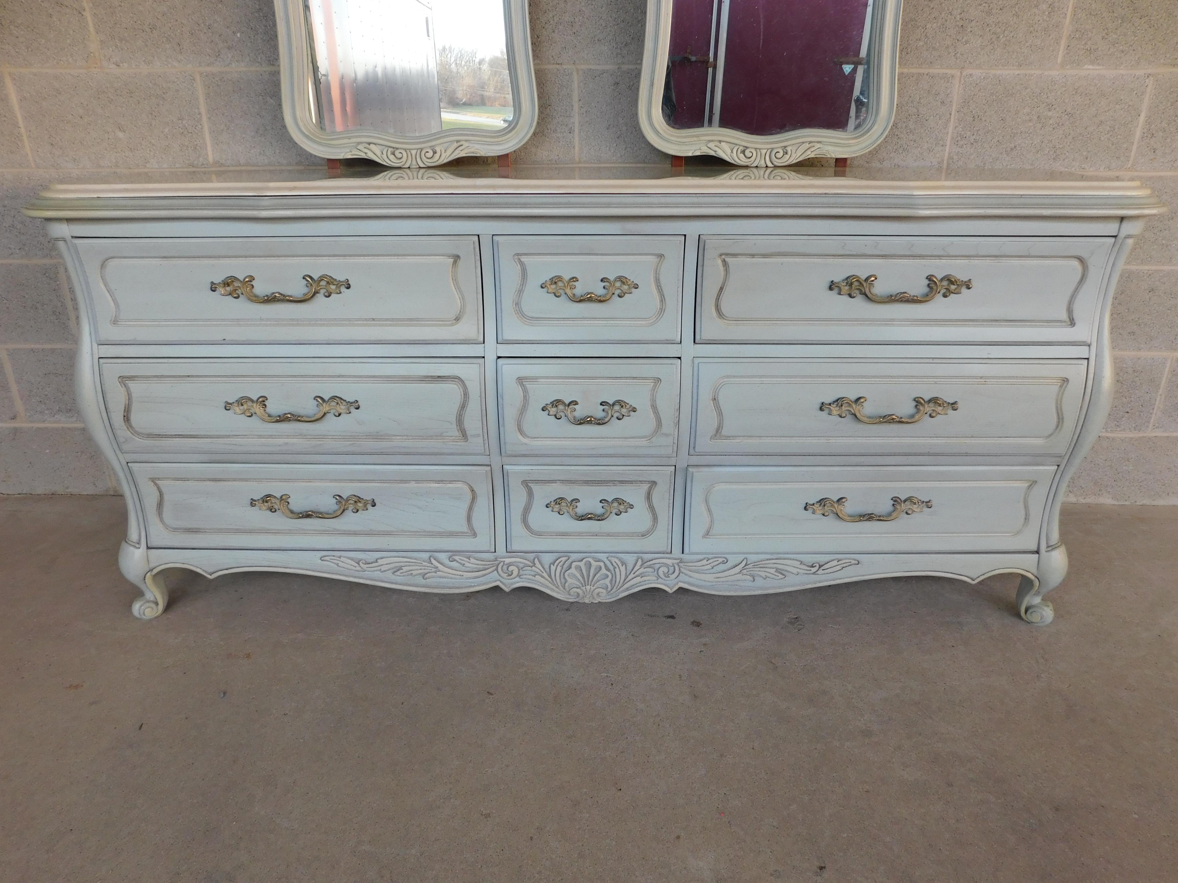 Features quality crafted solid construction, 9 Dovetailed Drawers, Factory Original Finish in Light Powder French Blue, Brass Hardware, Original Marble in Cream Light Tan  