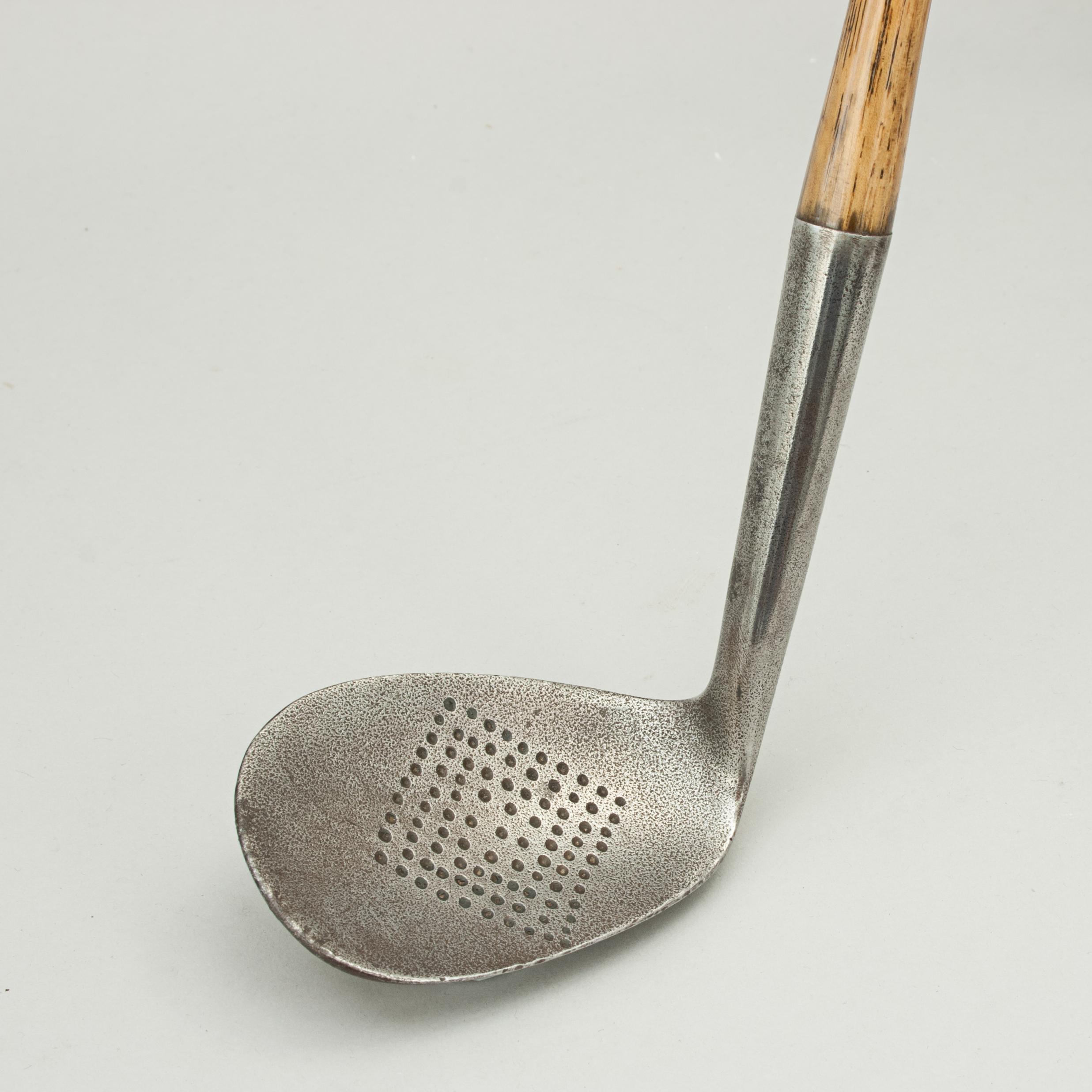 Hickory Shafted Niblick.
A good quality dish faced niblick golf club with hickory shaft. The head stamped on the back ' Special Niblick' warranted hand-forged
with a 'crossed clubs' cleek mark (possibly 'SJ Preve' runs through the cleek mark). A