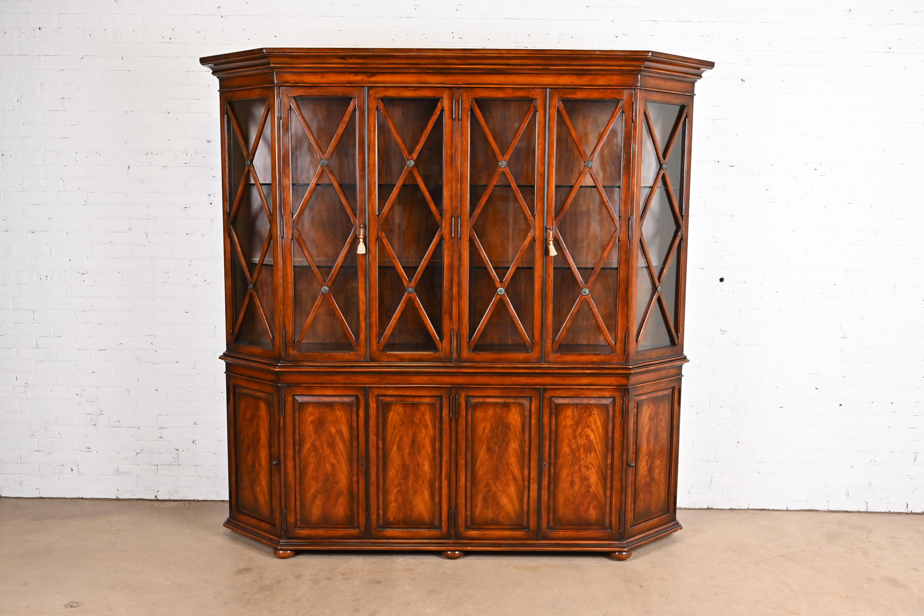 A gorgeous Georgian or Chippendale style large breakfront bookcase or dining cabinet

By Hickory White

USA, Circa Late 20th Century

Book-matched flame mahogany, with mullioned glass front doors. Cabinet locks, and key is included.

Measures: