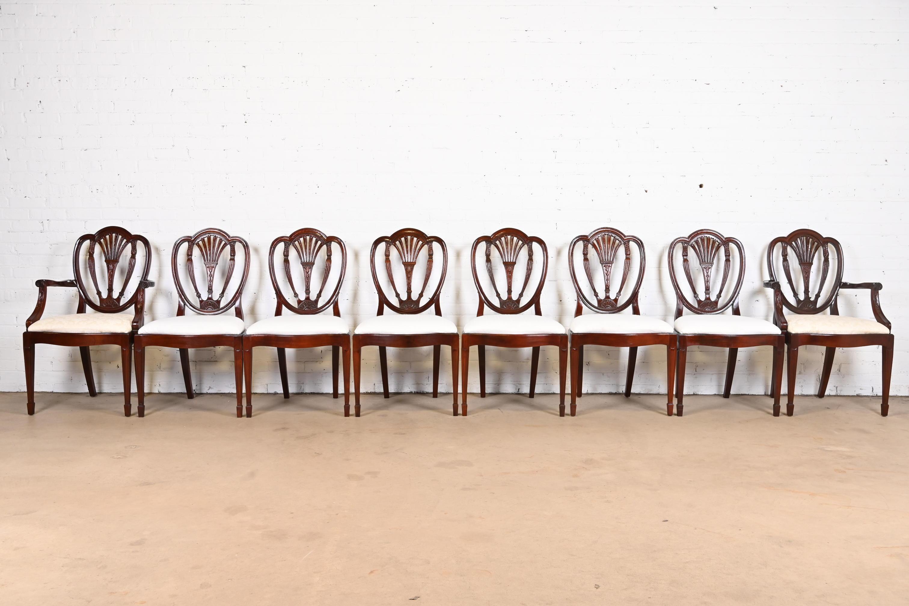 A gorgeous set of eight Georgian or Regency style shield back dining chairs.

In the manner of Baker Furniture 