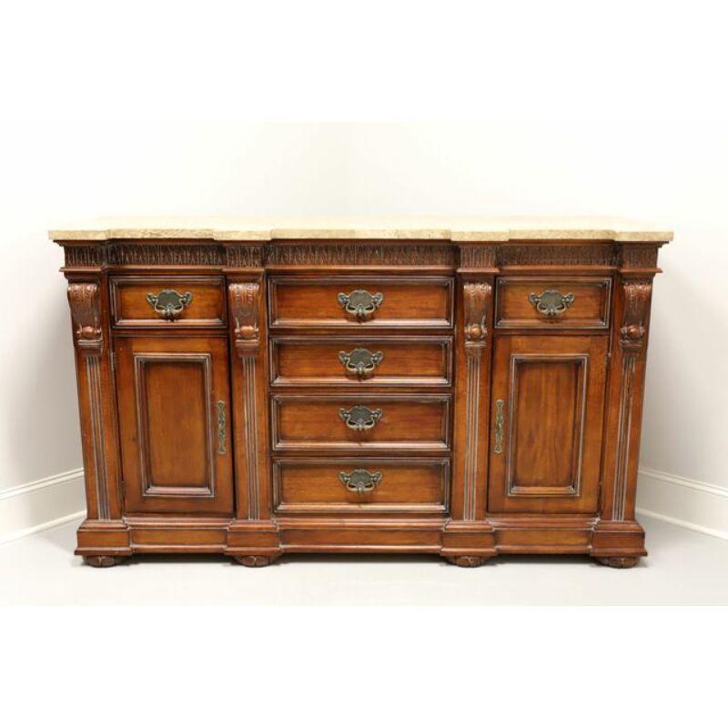 A Renaissance style, monumentally sized, tall credenza by Hickory White, from their Legends II Collection. Cherry wood with slightly distressed finish, marble top, brass hardware, corbel styling, fluted flat ball feet, carved foliate design to top