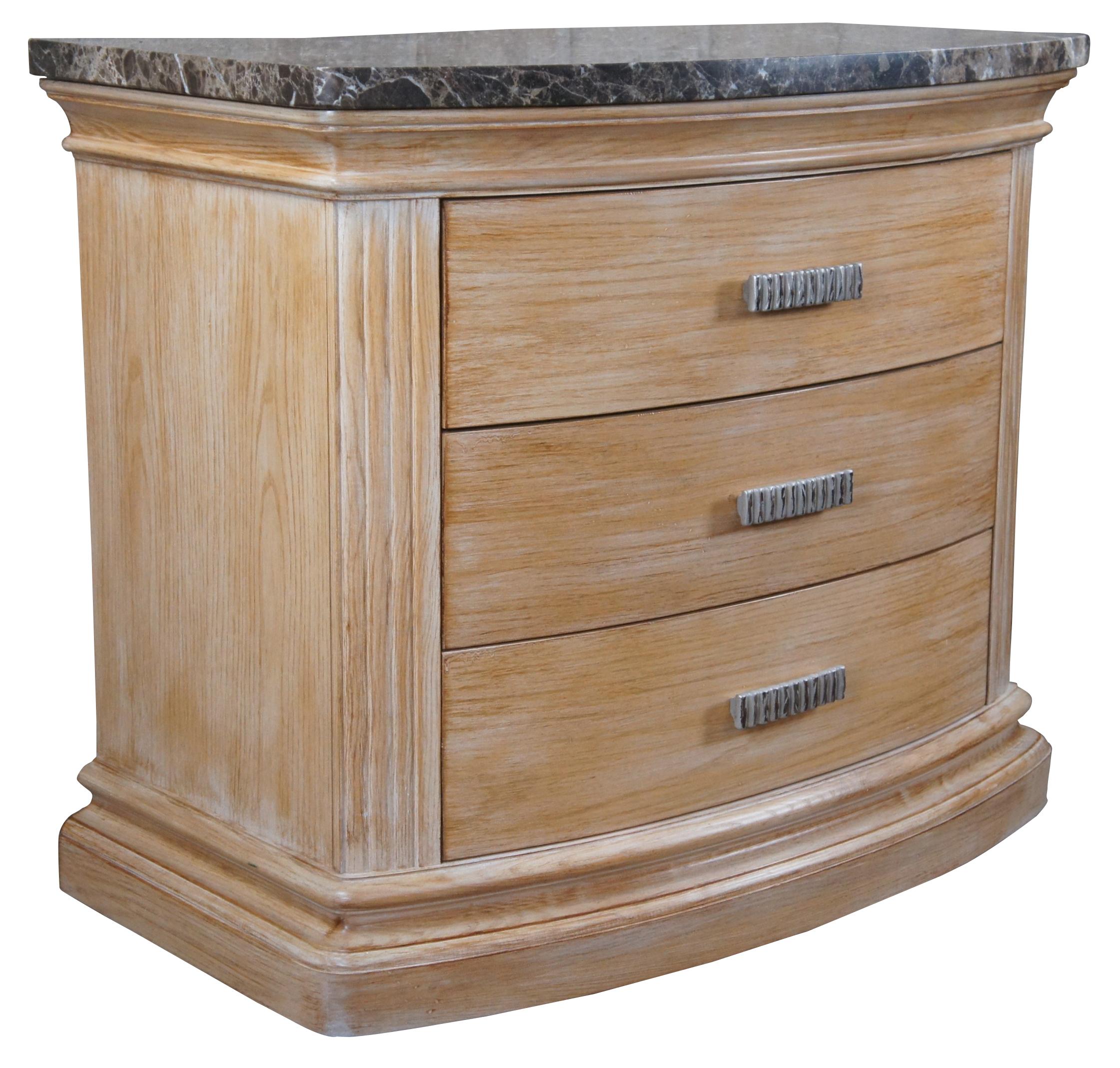 Hickory White Odyssey Collection modern bedside table. A demilune form made from pickled oak with three dovetailed drawers and a granite top.