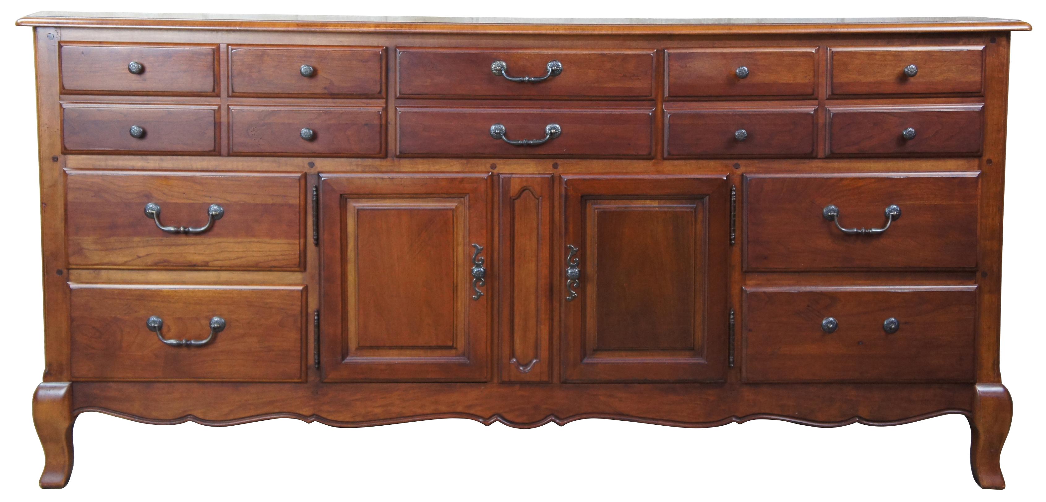 A traditional buffet by Hickory White. Drawing inspriration from French Provincial and Tuscan styling. Made from cherry with seven drawers and lower cabinet for storage.
   