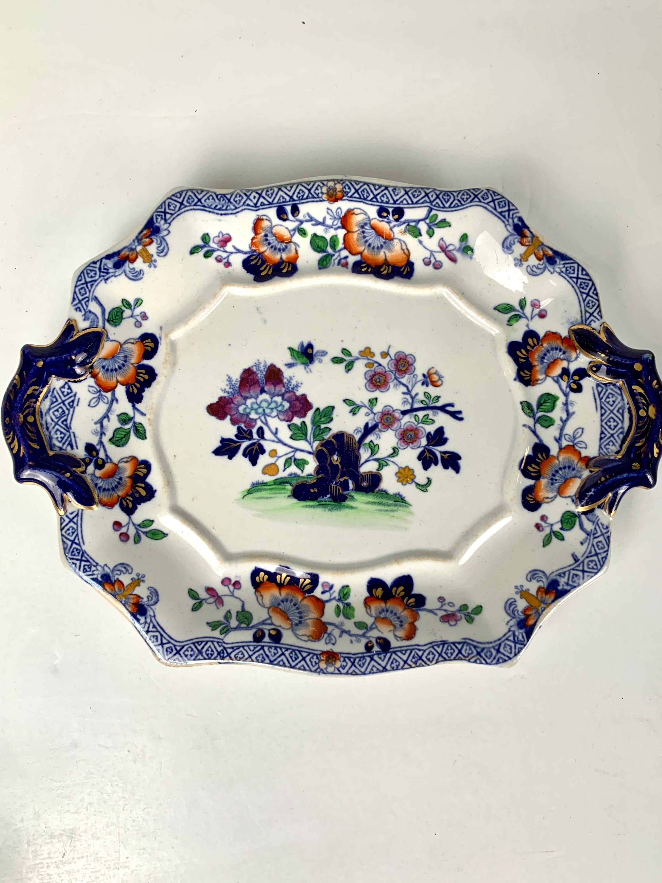 Made by Hicks and Meigh, England, circa 1820.
The items and prices are listed below:
Description of the group: The decoration is lovely: a butterfly hovers above a flower-filled garden.
We see purple peonies and pink fruit tree blossoms emanating