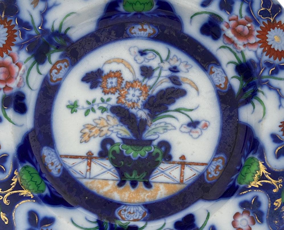 Hicks & Meigh enameled Imari ironstone plate in cobalt, vivid green and iron red. Center vase with chrysanthemums, peonies and blossoms. Blue underglaze on reverse with mark and numbered 3/1053. Regency era, England, circa 1822 - 1835.