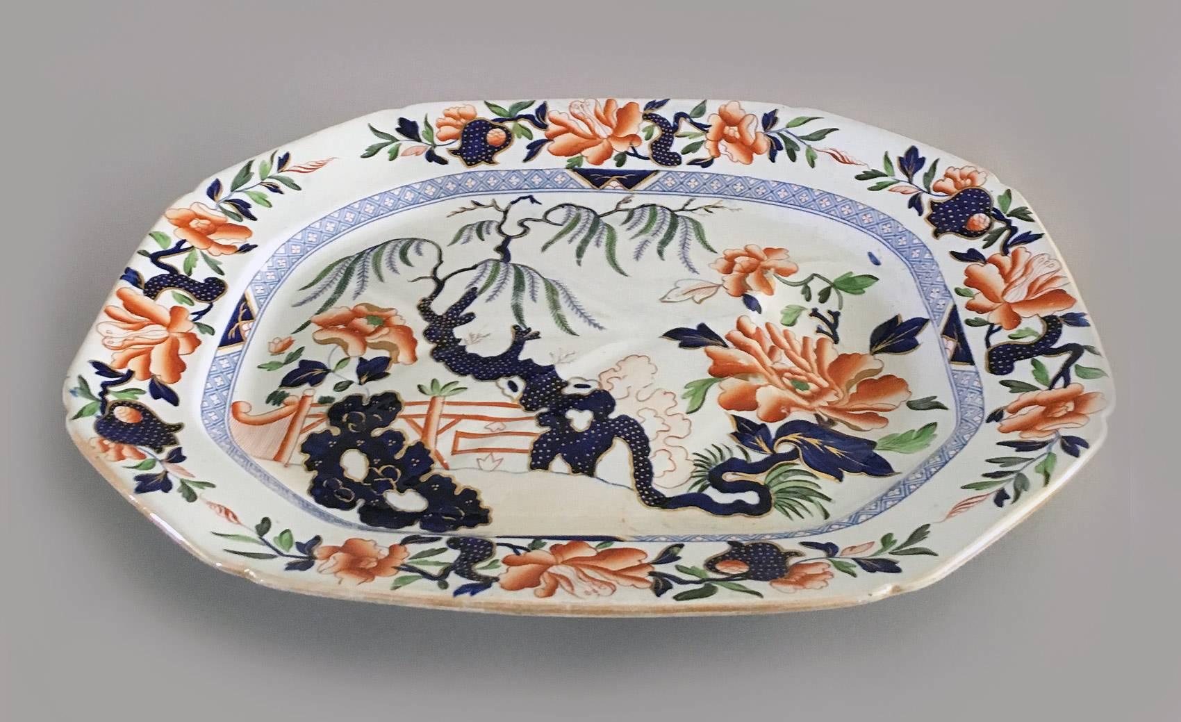 A large Hicks & Meigh Staffordshire meat platter, decorated with peonies and a willow tree in the Japan colors of cobalt blue and orange with gilding. The back has the blue printed mark “Stone China” no. 7 with the royal coat-of-arms with an inner