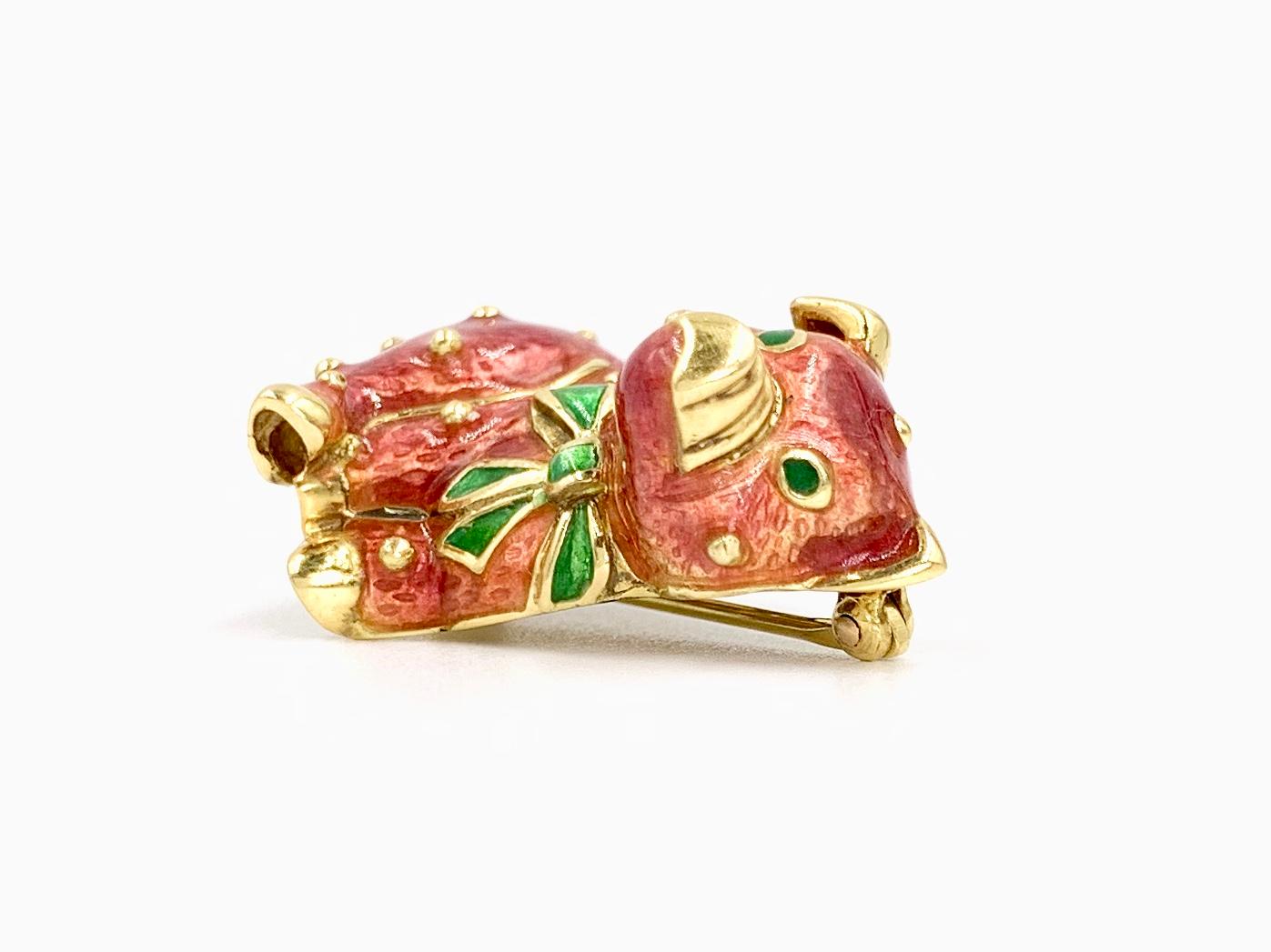 Adorable 18 karat yellow gold and hand painted enamel pig brooch by Hidalgo. This charming pink enamel pig dons a green bow around the neck with the signature Hidalgo yellow gold beading throughout the piece. Enamel is in near pristine