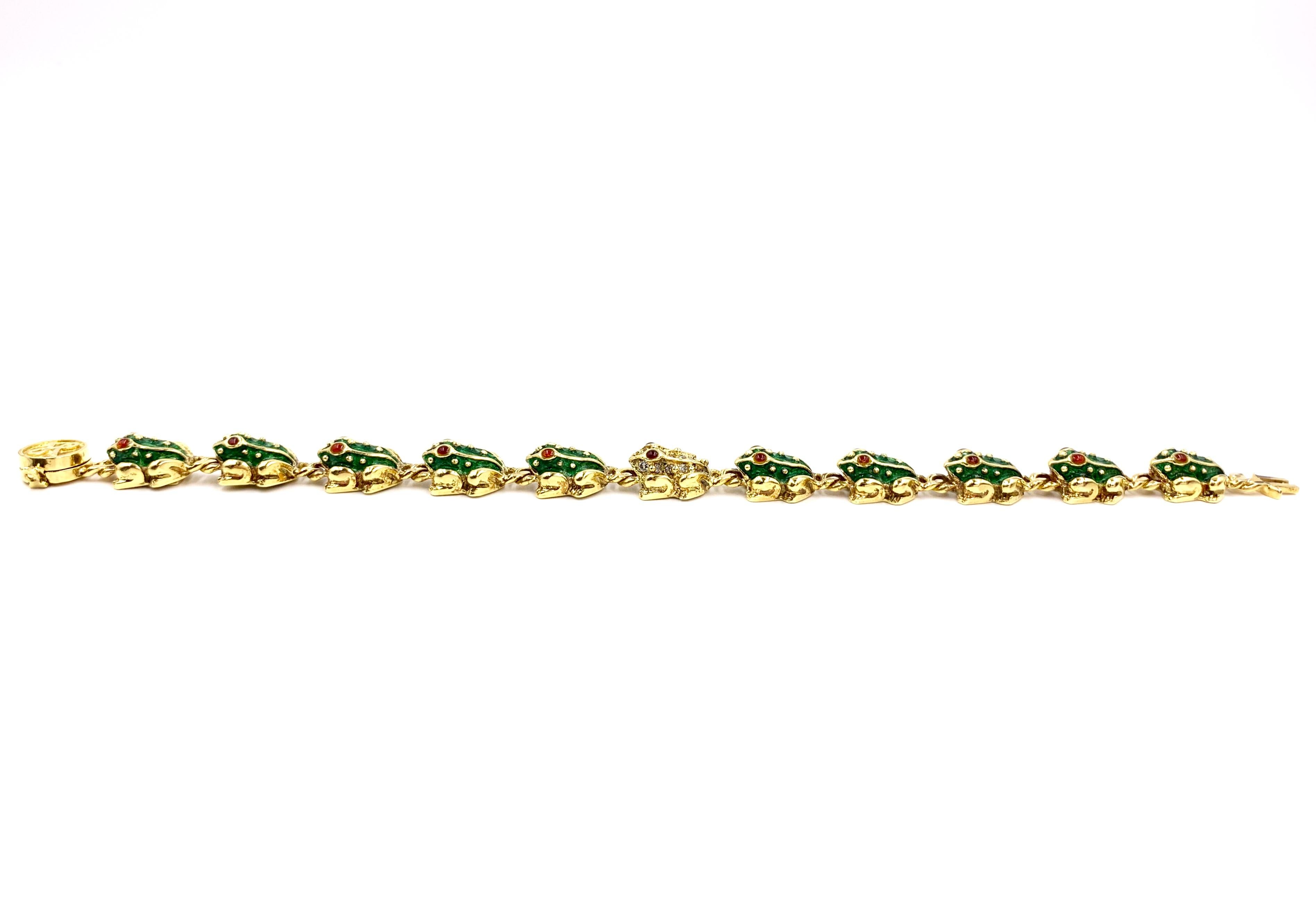 In classic Hidalgo style, a polished 18 karat yellow gold and green enamel frog bracelet featuring 22 cabochon ruby eyes and 17 round diamonds set on the center gold frog. 
Width of bracelet is 10mm