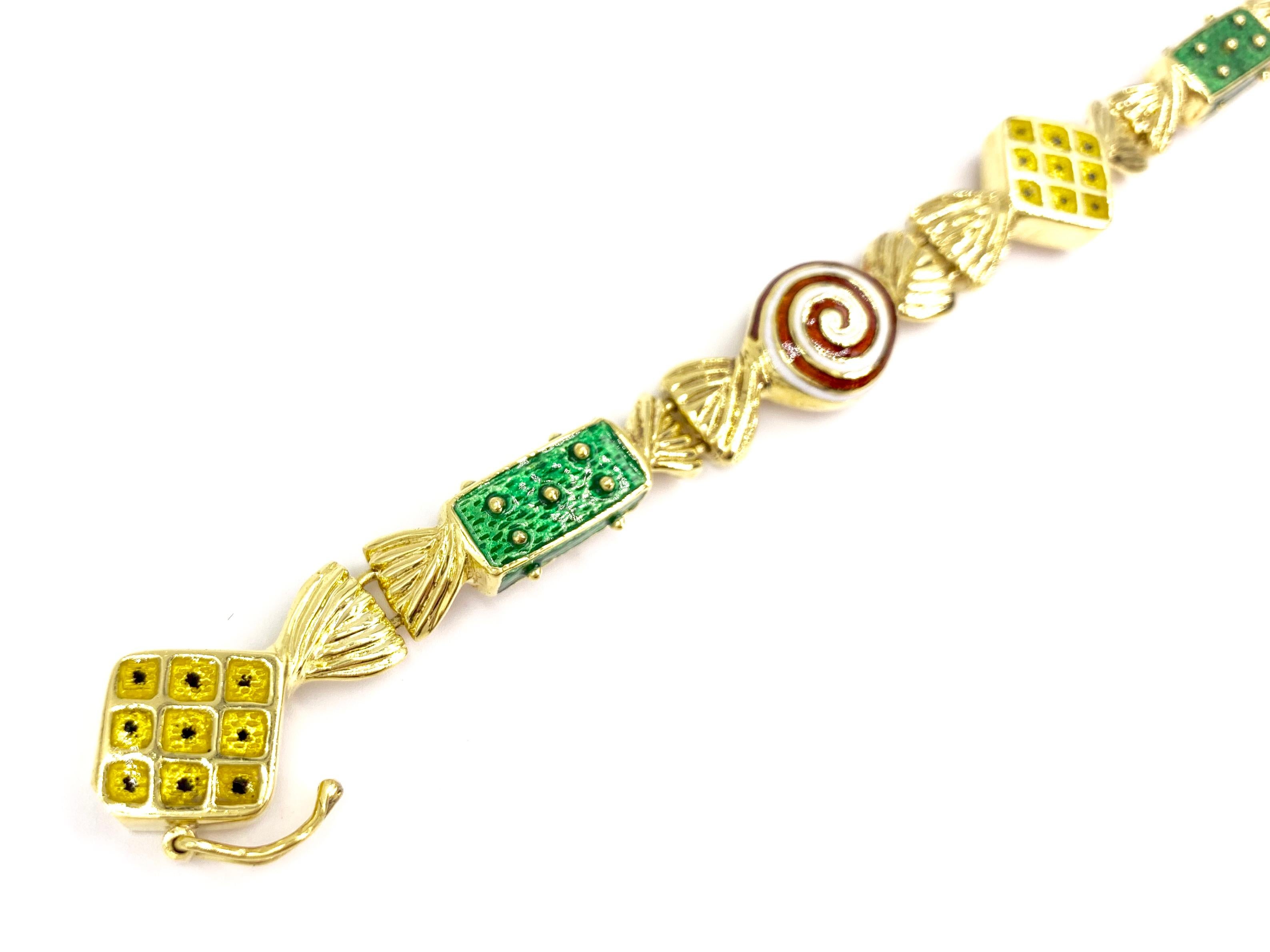 A whimsical and wearable well made 18 karat yellow gold bracelet featuring hand painted enamel hard candy design links by expert jeweler, Hidalgo. Red and white swirls, green textured and yellow patterned hard candies are made with fluted gold ends