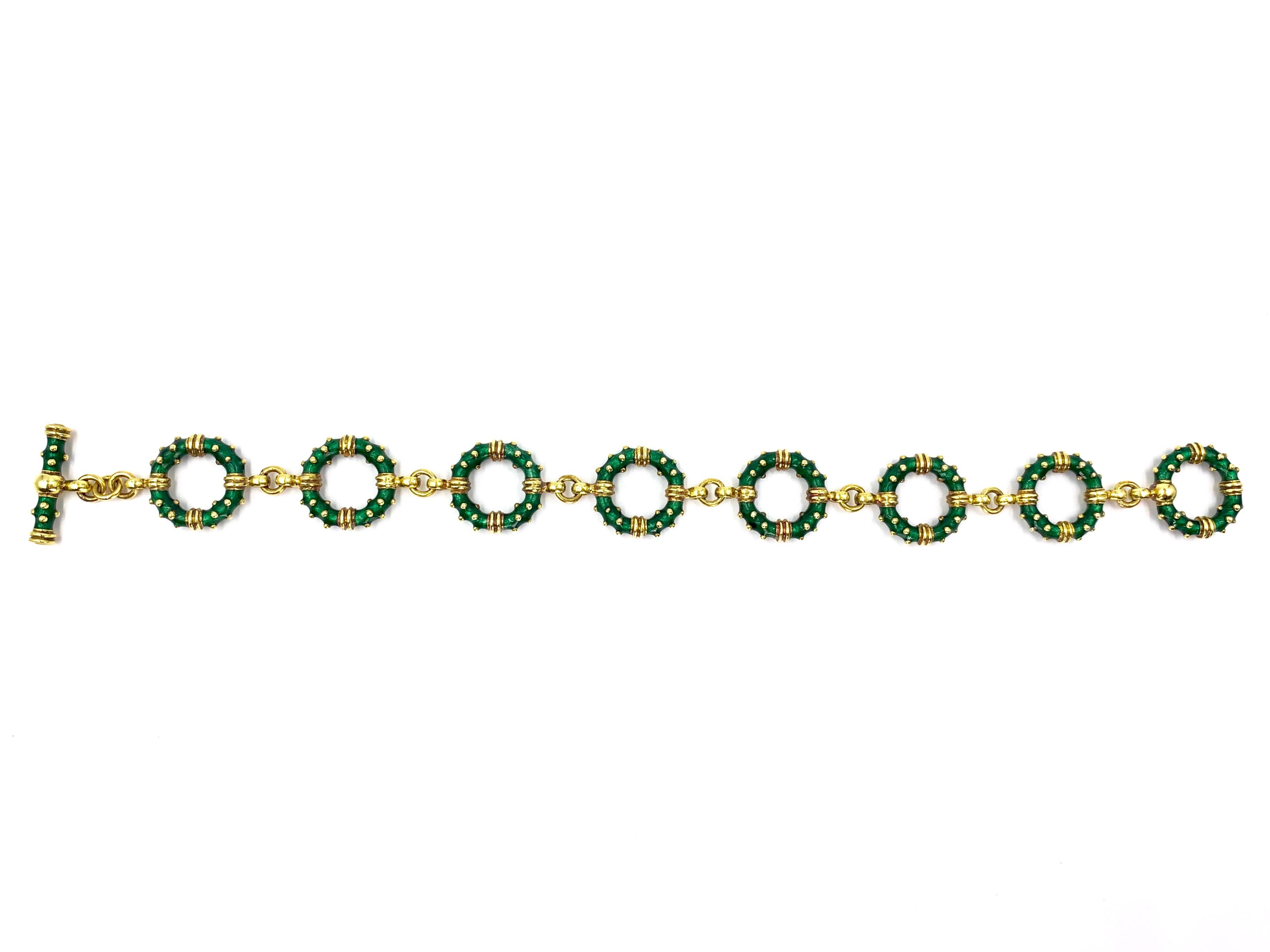18 Karat yellow gold and beautiful, rich green enamel circle linked toggle bracelet by Hildalgo. Bracelet features eight 11mm round links with the signature Hidalgo textured polished gold beading throughout. Green color is a beautiful shade of