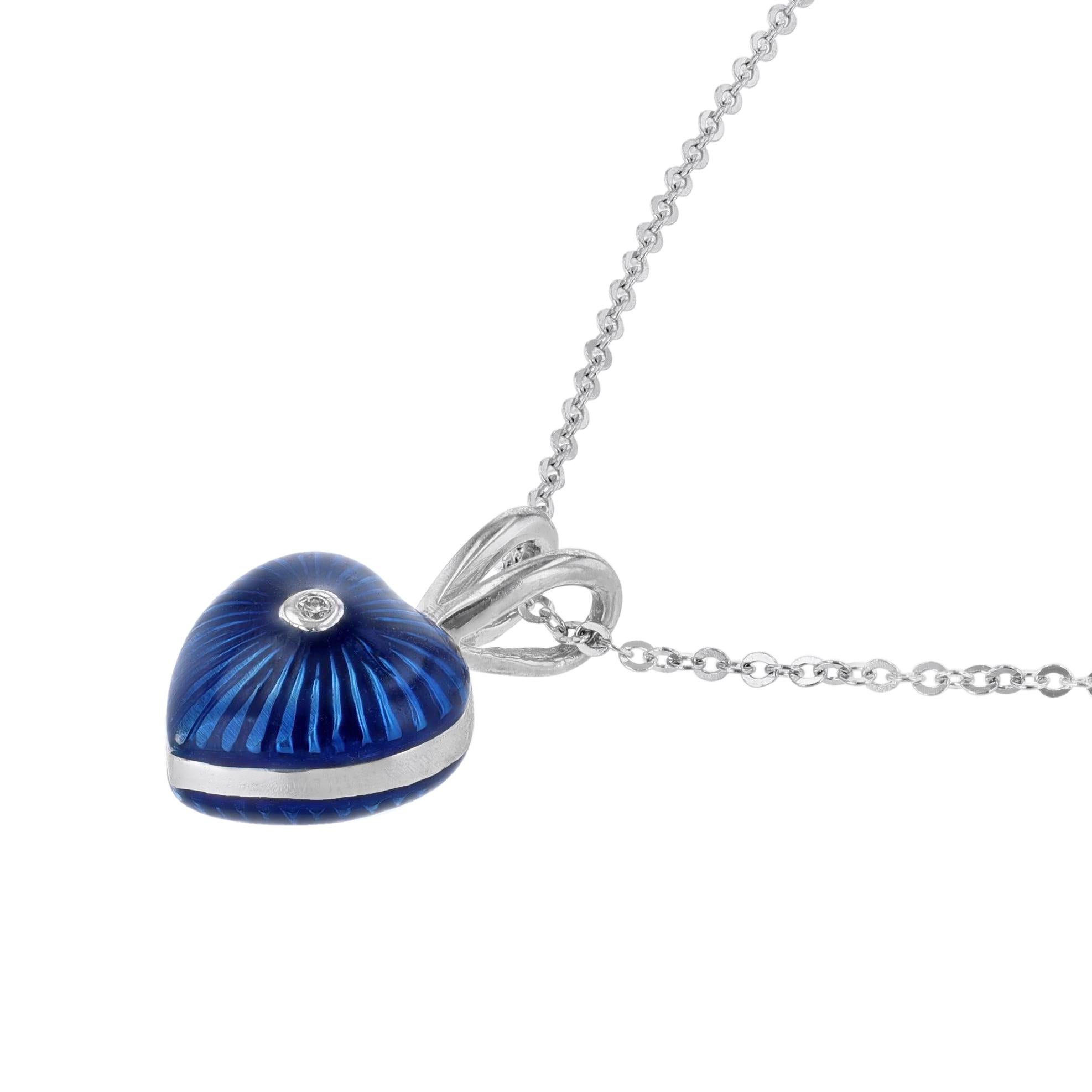 This necklace is made in 18K white gold and blue enamel. It features a heart pendant with a 0.01 carat center diamond.