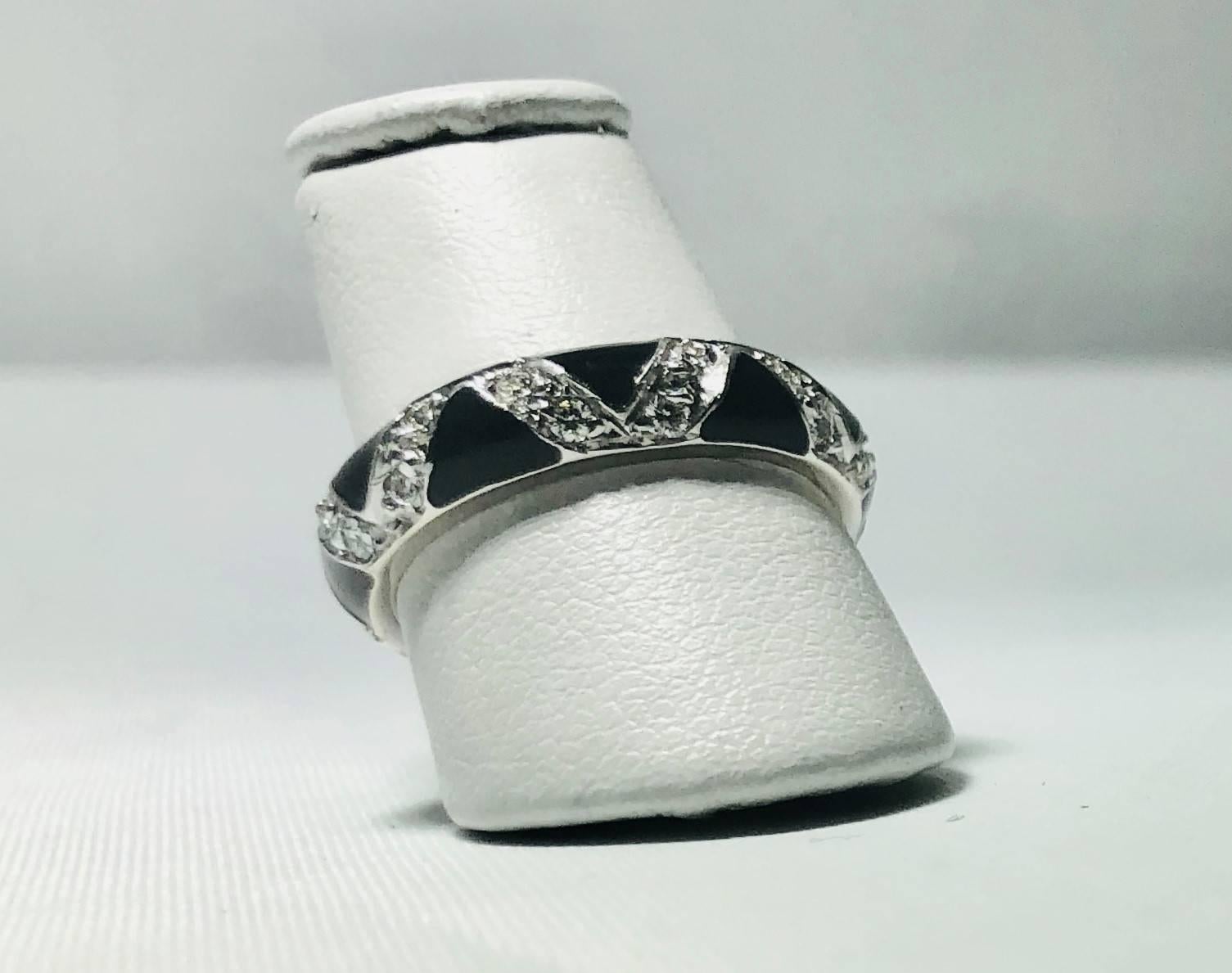 Hidalgo 18 Karat White Gold Diamonds and black enamel stackable band ring. This Hidalgo classic creation is created in 18 white gold and weighs 4.9 grams and 3.2dwt.. There are 24 full cut round diamonds .48 carats total weight, average color-G-H