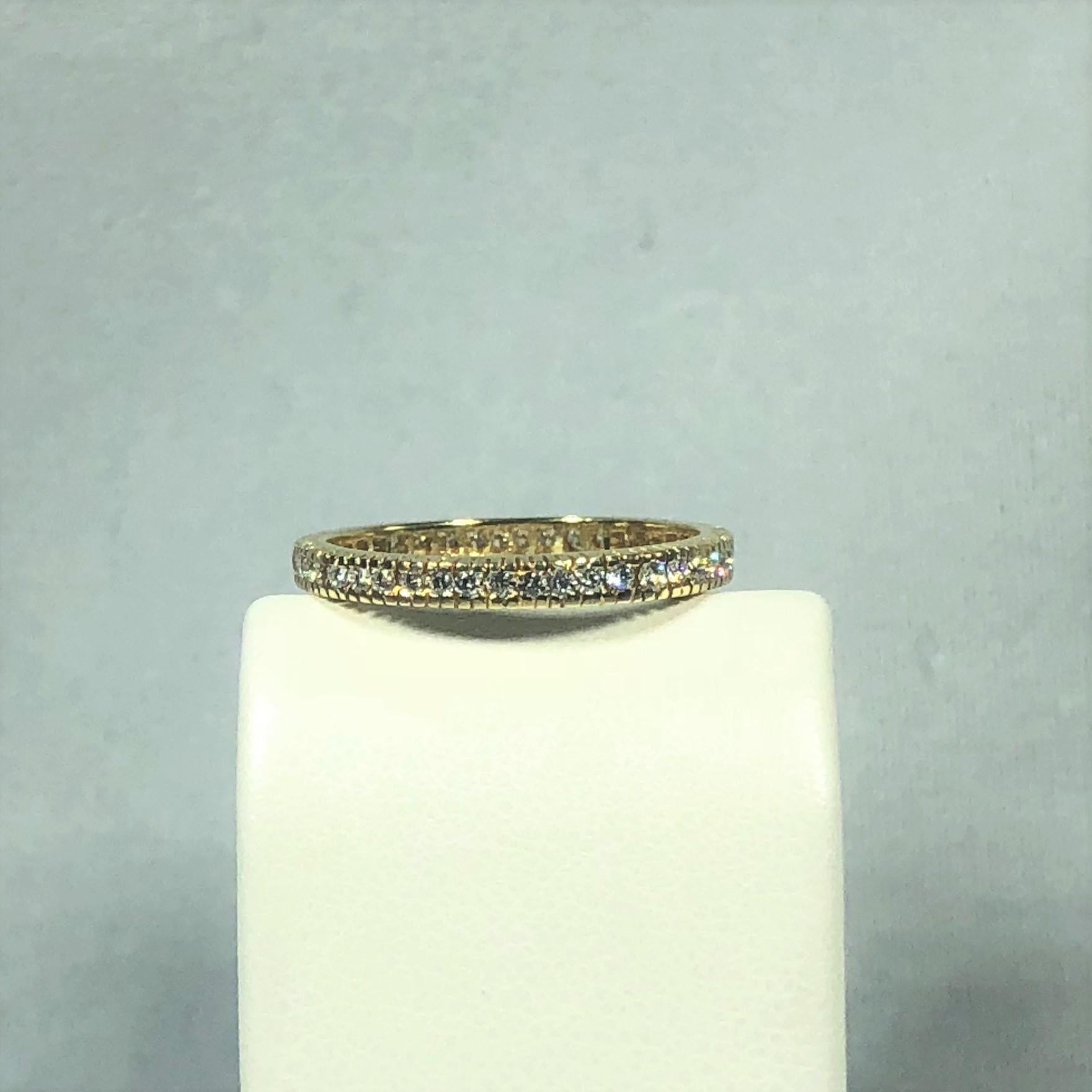 Hidalgo 18 Karat Yellow Gold and Diamond Eternity Band. This Hidalgo piece is created in 18 karat yellow gold, weight 1.7 grams. 45 channel set  1.5mm diamonds are around the entire band, in eternity style fashion. Total carat weight =.46 ct.,
