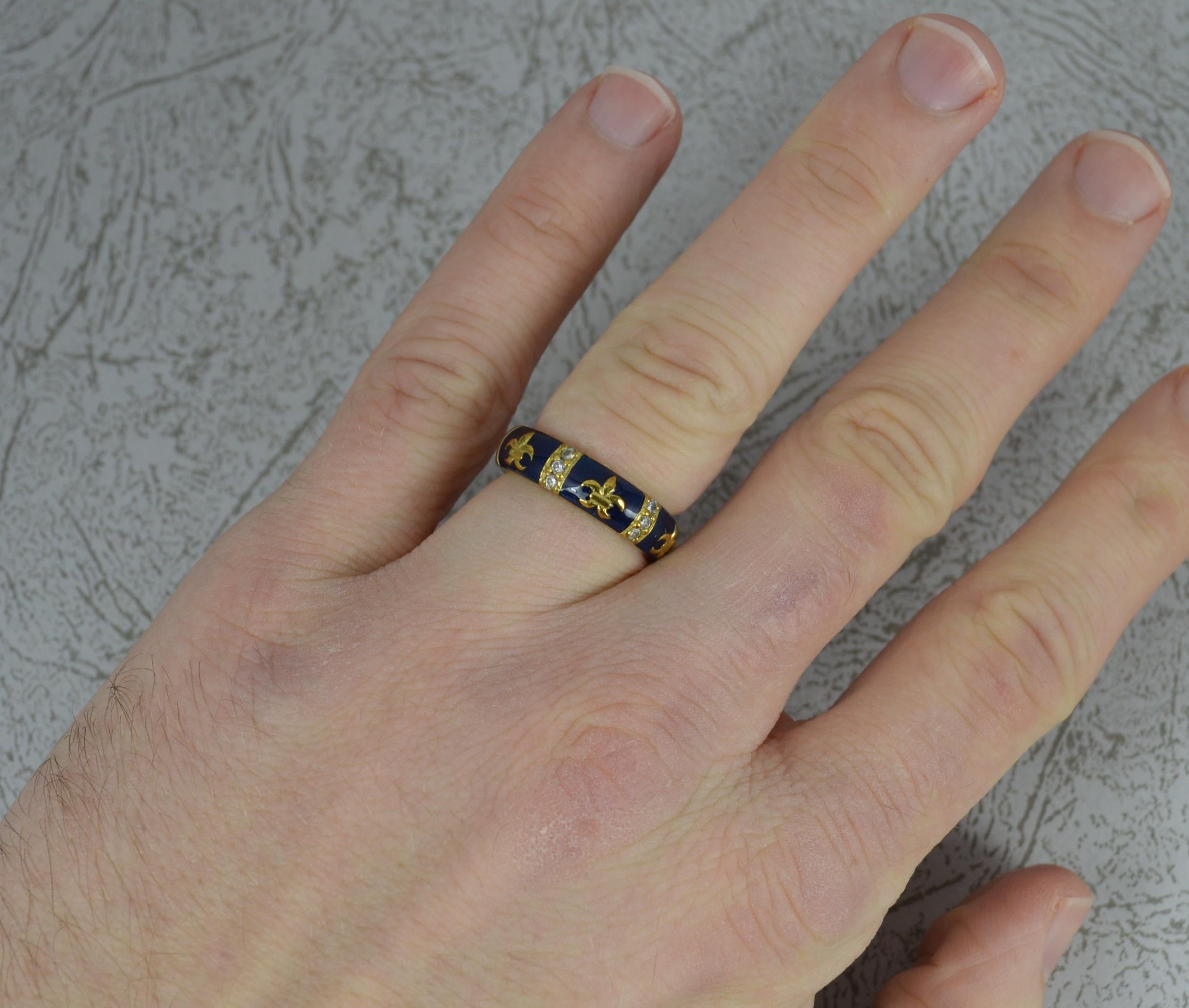 A very stylish Hidalgo designer ring.
18 carat yellow gold example.
Vivid blue enamel full eternity band with gold fleur de lis highlights.
Two columns of three diamonds to front. 
5mm wide band.

CONDITION ; Excellent. Clean and solid band. Well