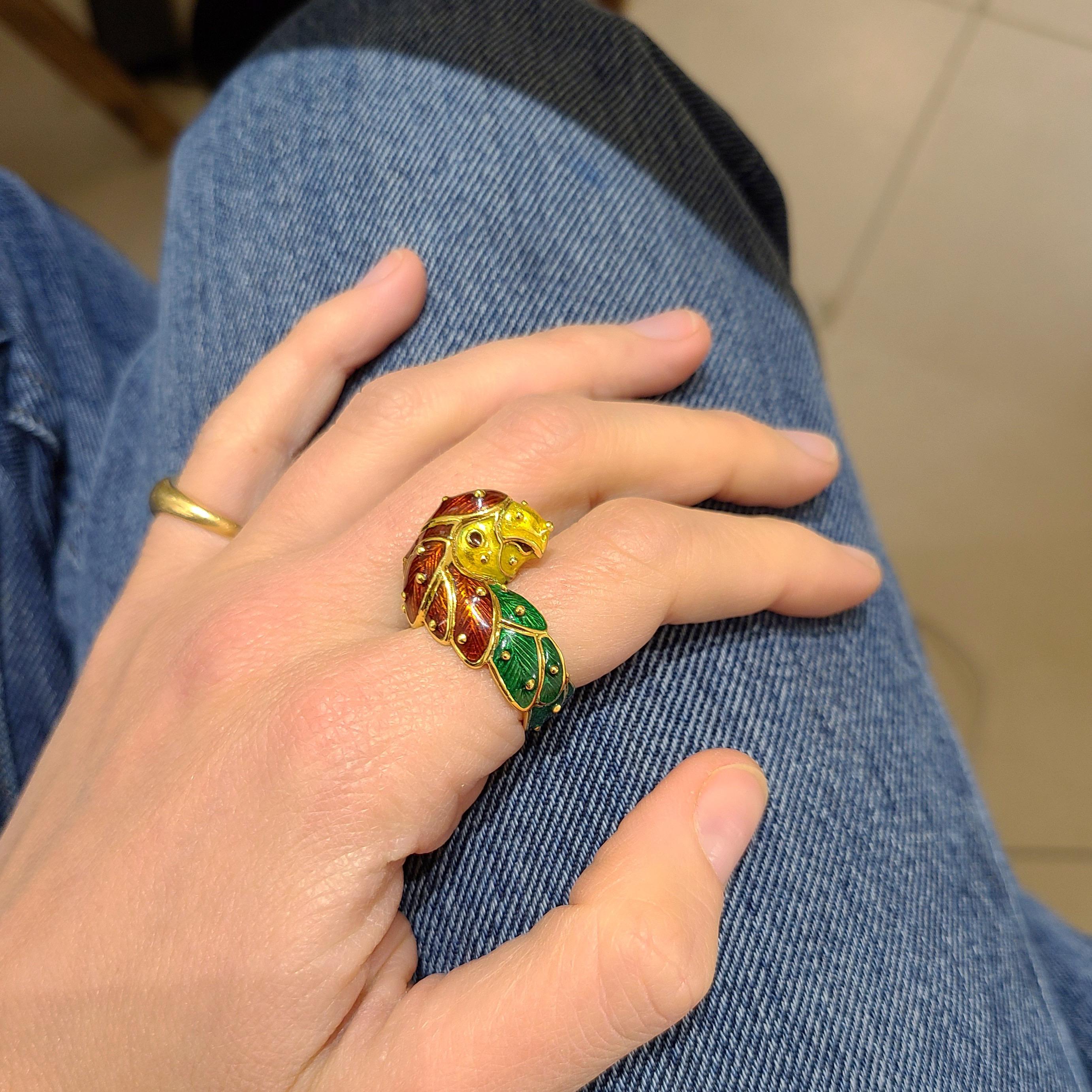 This 18 karat yellow gold parrot ring was designed by Hidalgo. The company is most noted for their beautiful enamel work. This ring is the perfect example. The parrot is crafted with red and green enamel for the feathers and yellow enamel for his