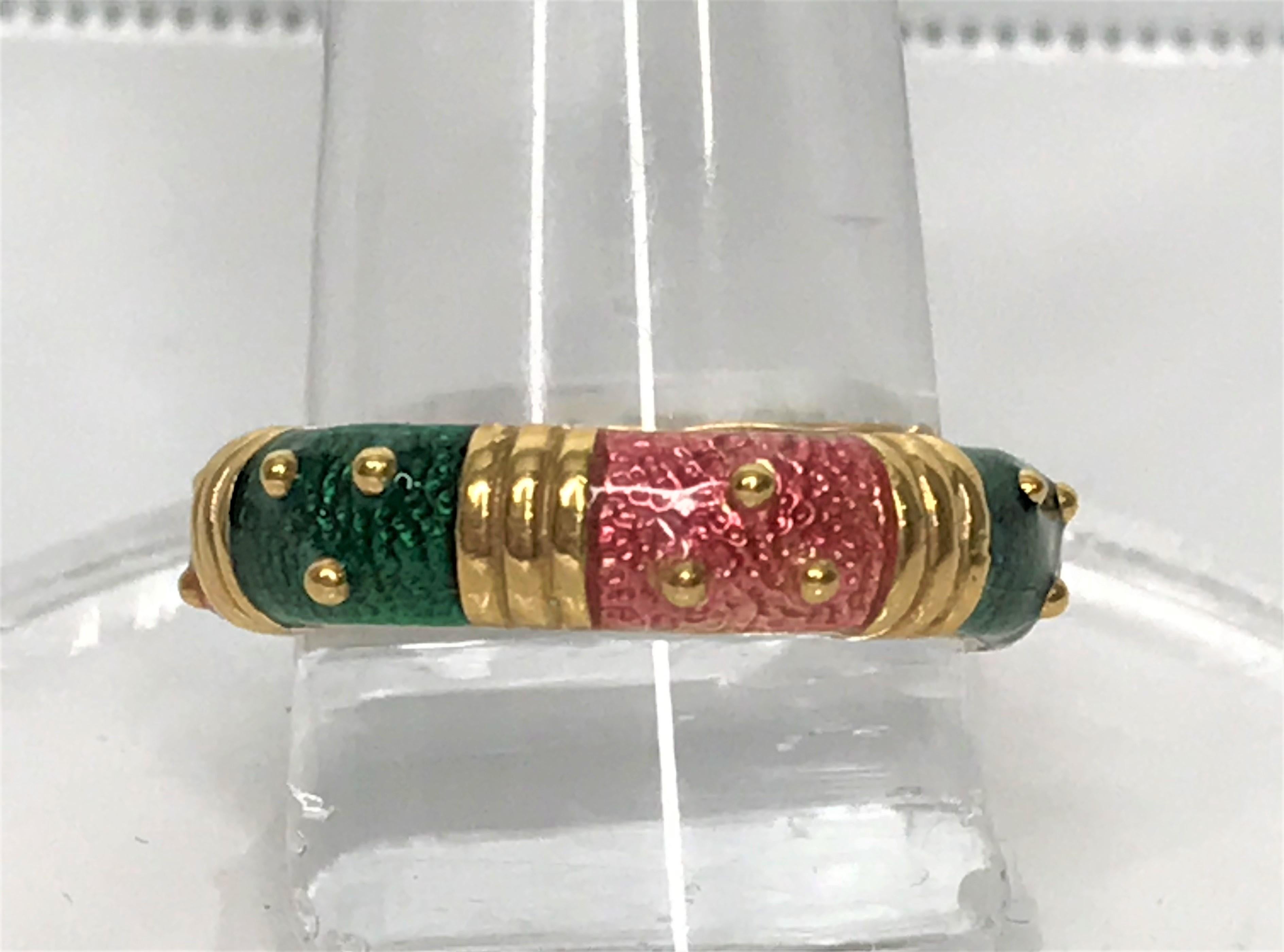 By designer Hidalgo Jewelry, this beautiful pink and green ring combination is a rare find.
18 karat yellow gold.
Alternating pink and green enamel with gold accents in between.
Approximately 5mm wide, overall.
Stamped 