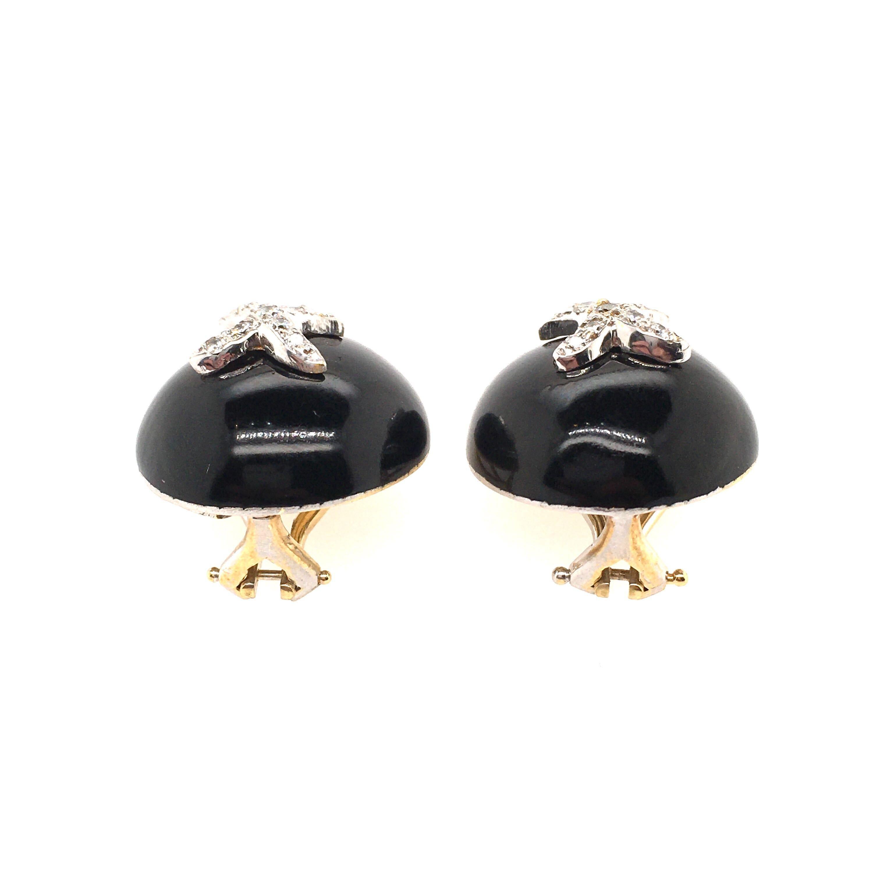 A pair of 18 karat yellow gold, enamel and diamond earrings. Hidalgo. Designed as a black enamel domed button, enhanced by a pave set diamond X motif. Diameter is approximately 5/8 inches, gross weight is approximately 17.8 grams. Stamped Hidalgo,