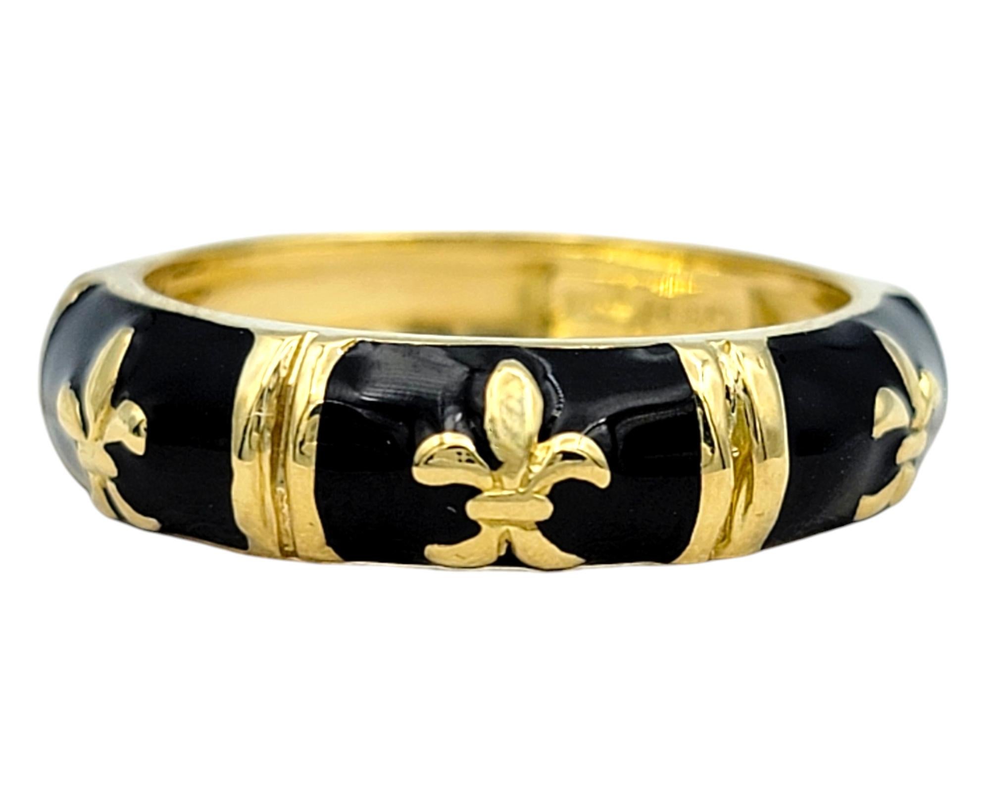 Ring Size: 6 

Add a touch of timeless elegance to your collection with this stunning Hidalgo black enamel fleur-de-lis band ring, crafted in luxurious 18 karat yellow gold. The band features a bold yet sophisticated design with black enamel panels,