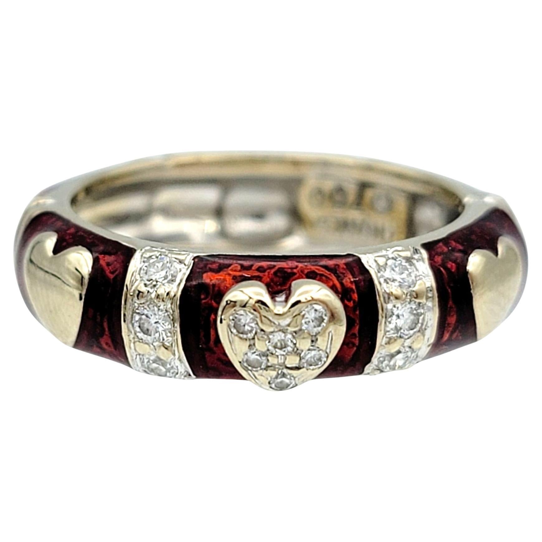 Ring Size: 6 

Celebrate romance and elegance with this authentic Hidalgo stackable band ring, crafted in 18 karat white and yellow gold. The band is adorned with rich red enamel and delicate hearts, creating a striking contrast that enhances its