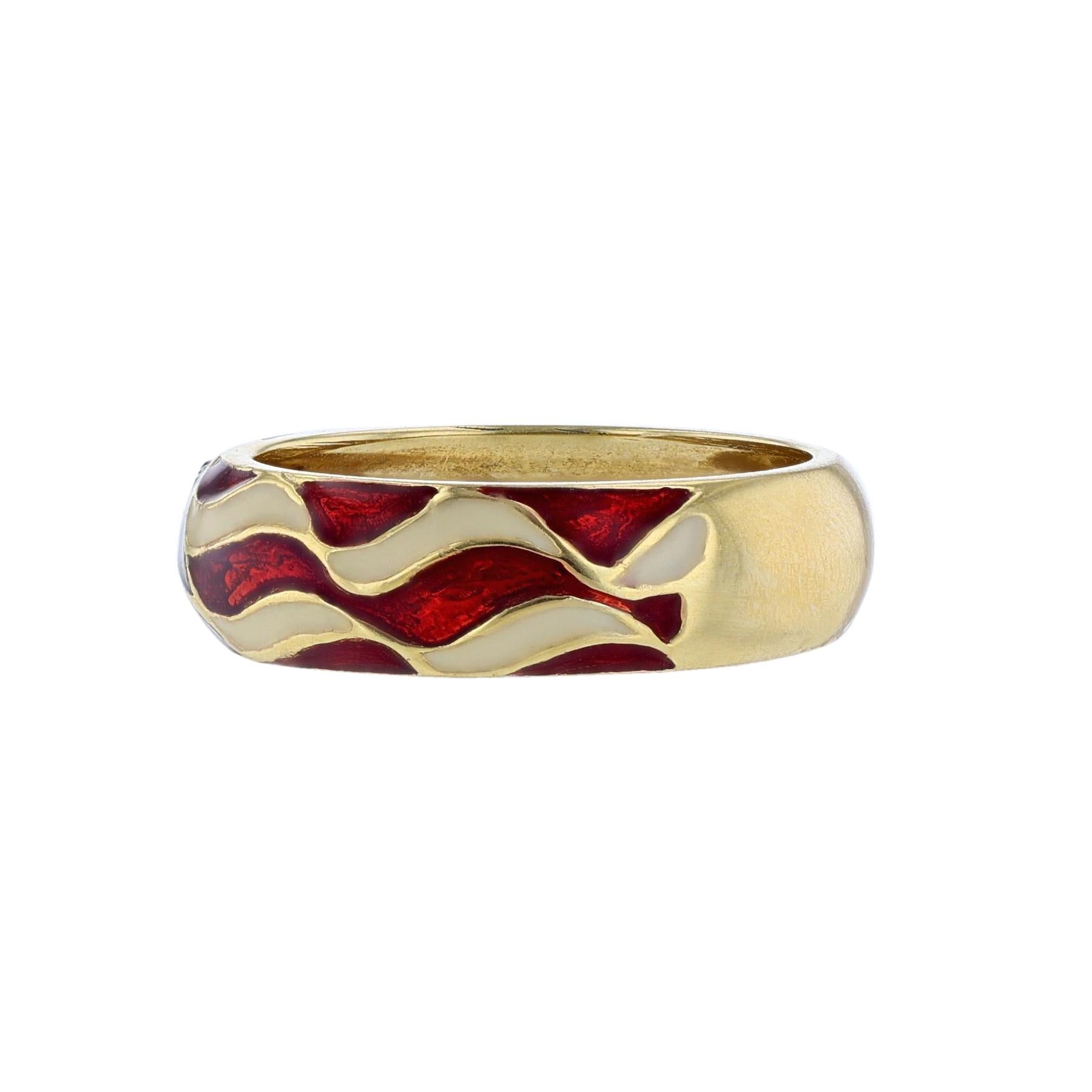 This ring is made in 18k yellow gold. It features the United States flag of red, white, and blue enamel. Along with 5 round cut diamonds in yellow gold stars weighing 0.05ct.