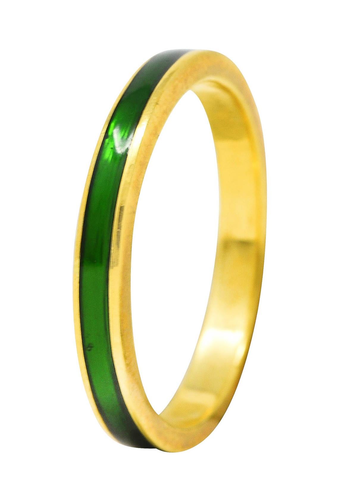 Band ring features a recessed enamel channel fully around. Glossy and transparent medium green in color. With high polished gold surround. Stamped 750 for 18 karat gold. Fully signed with maker's mark for Hidalgo. Circa: 1990's. Ring size: 8 1/4 and
