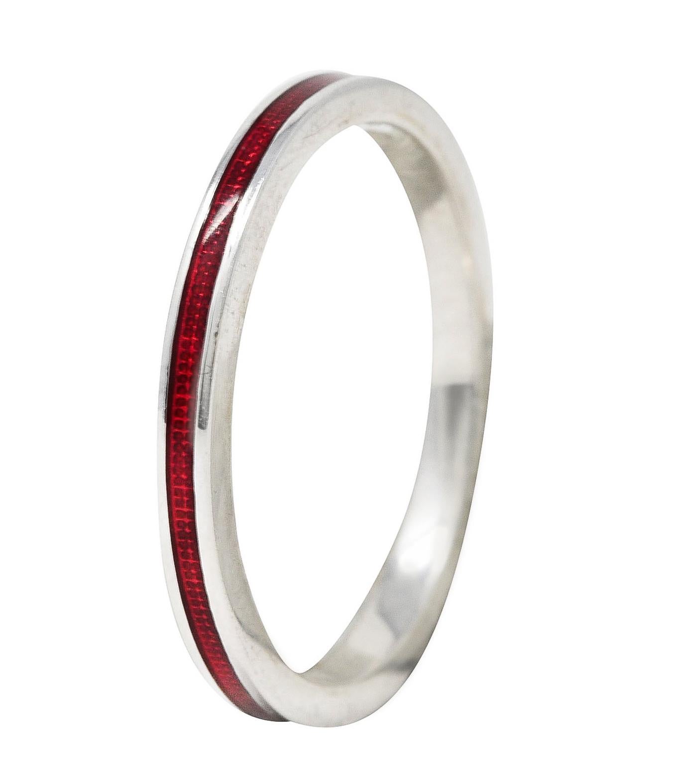 Band ring features a recessed guilloche enamel channel fully around. Glossy and transparent medium red in color over engraved linear pattern. With high polished gold surround. Stamped 750 for 18 karat gold. Signed with maker's mark for Hidalgo.