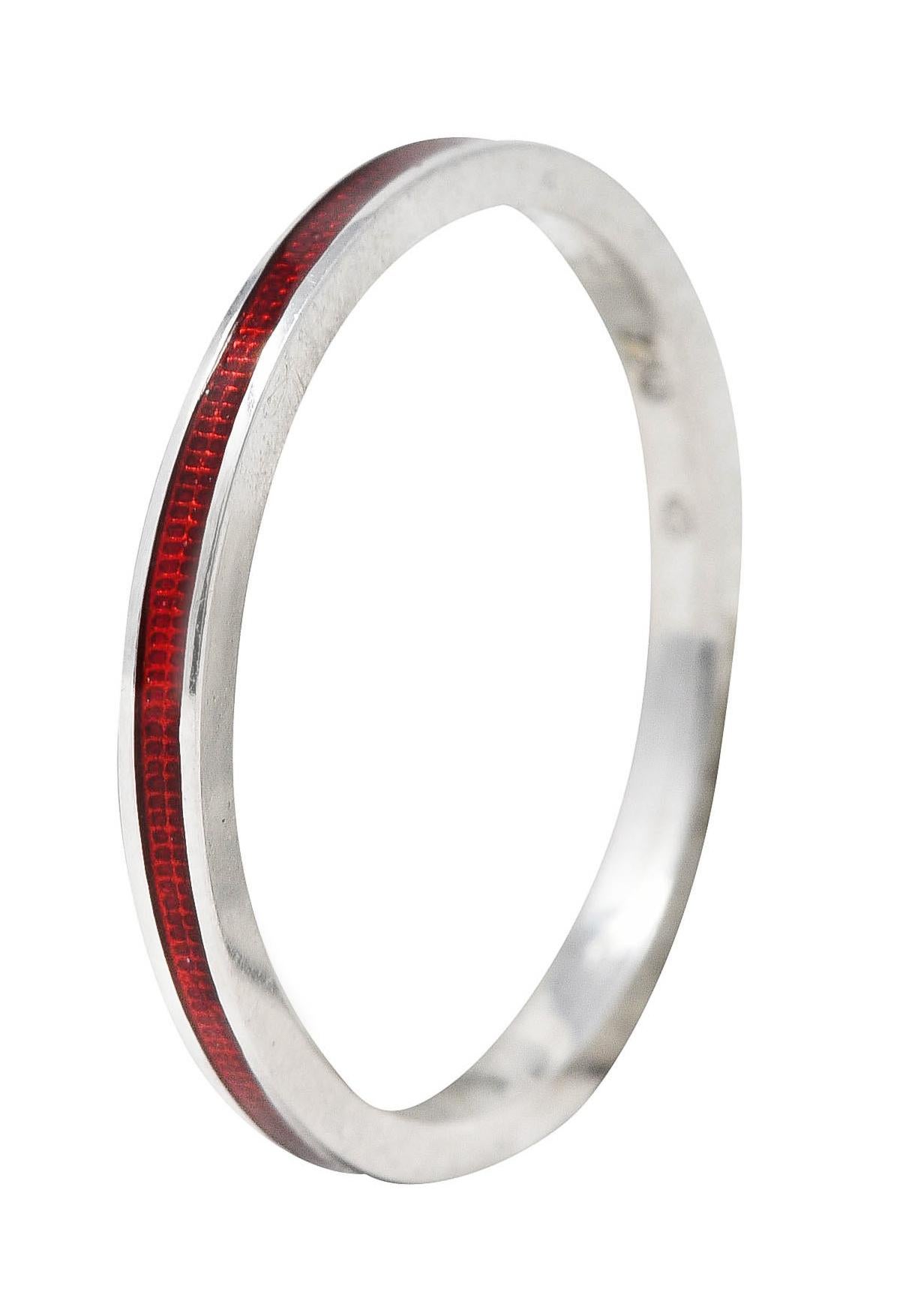 Band ring features a recessed guilloche enamel channel fully around. Glossy and transparent medium red in color over engraved linear pattern. With high polished gold surround. Stamped 750 for 18 karat gold. Signed with maker's mark for Hidalgo.