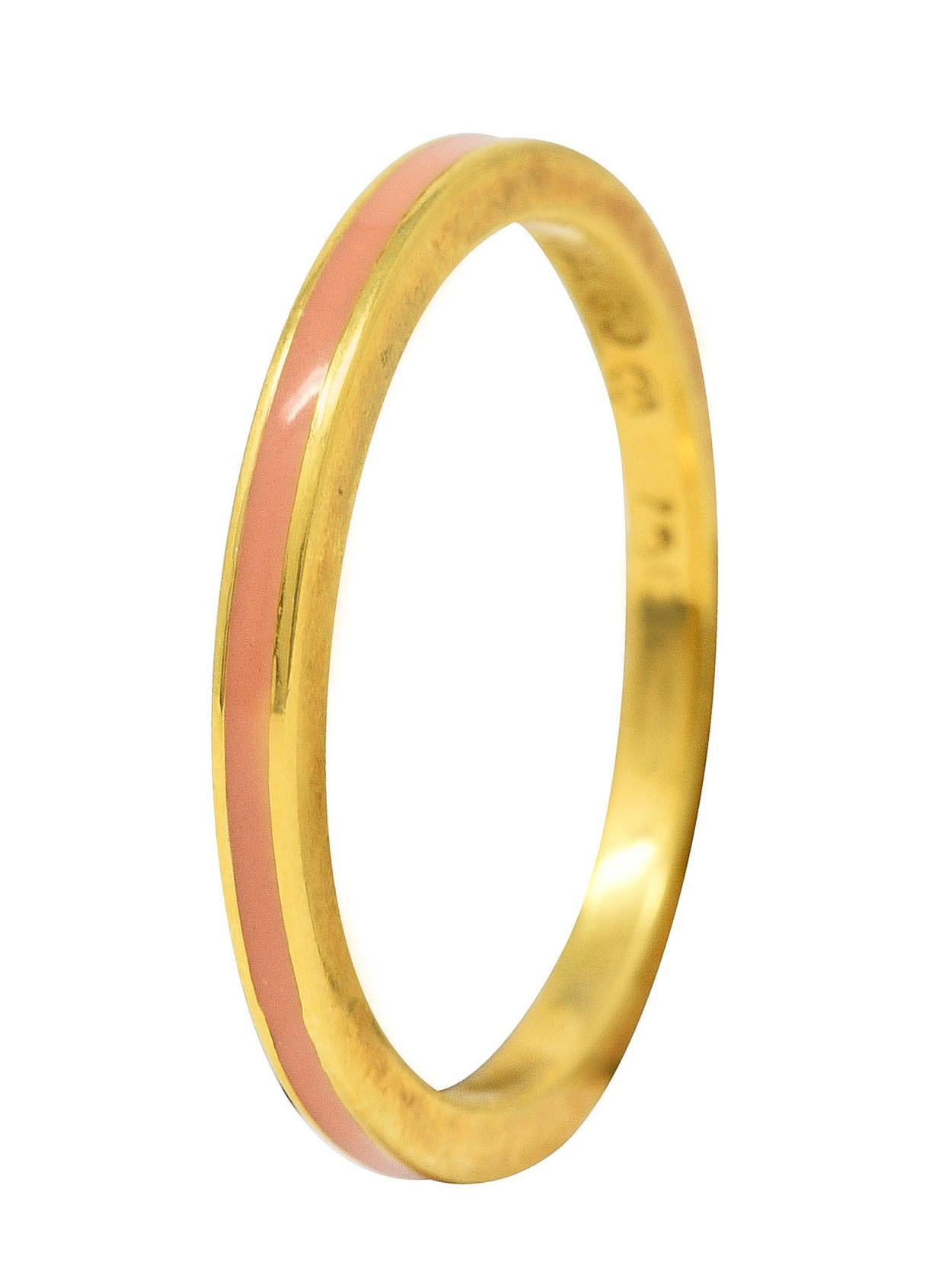 Band ring features a recessed enamel channel fully around. Glossy and opaque light peach in color. With high polished gold surround. Stamped 750 for 18 karat gold. Fully signed with maker's mark for Hidalgo. Circa: 1990's. Ring size: 6 3/4 and not