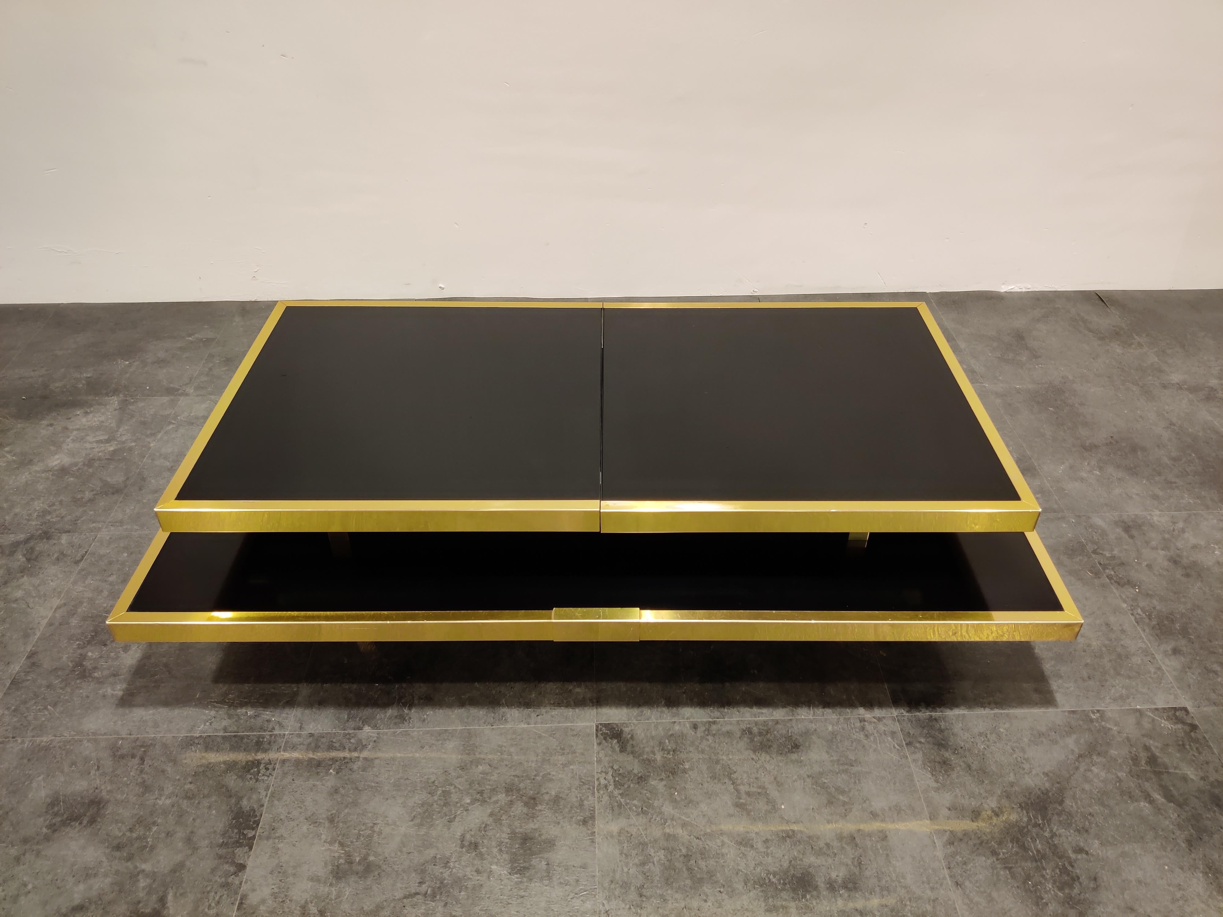 Rare hidden bar coffee table with a sliding table top.

Made from brass and lacquered wood.

Inside you can store six bottles and glasses.

Good original condition.

Measures: Height 36cm/14.17