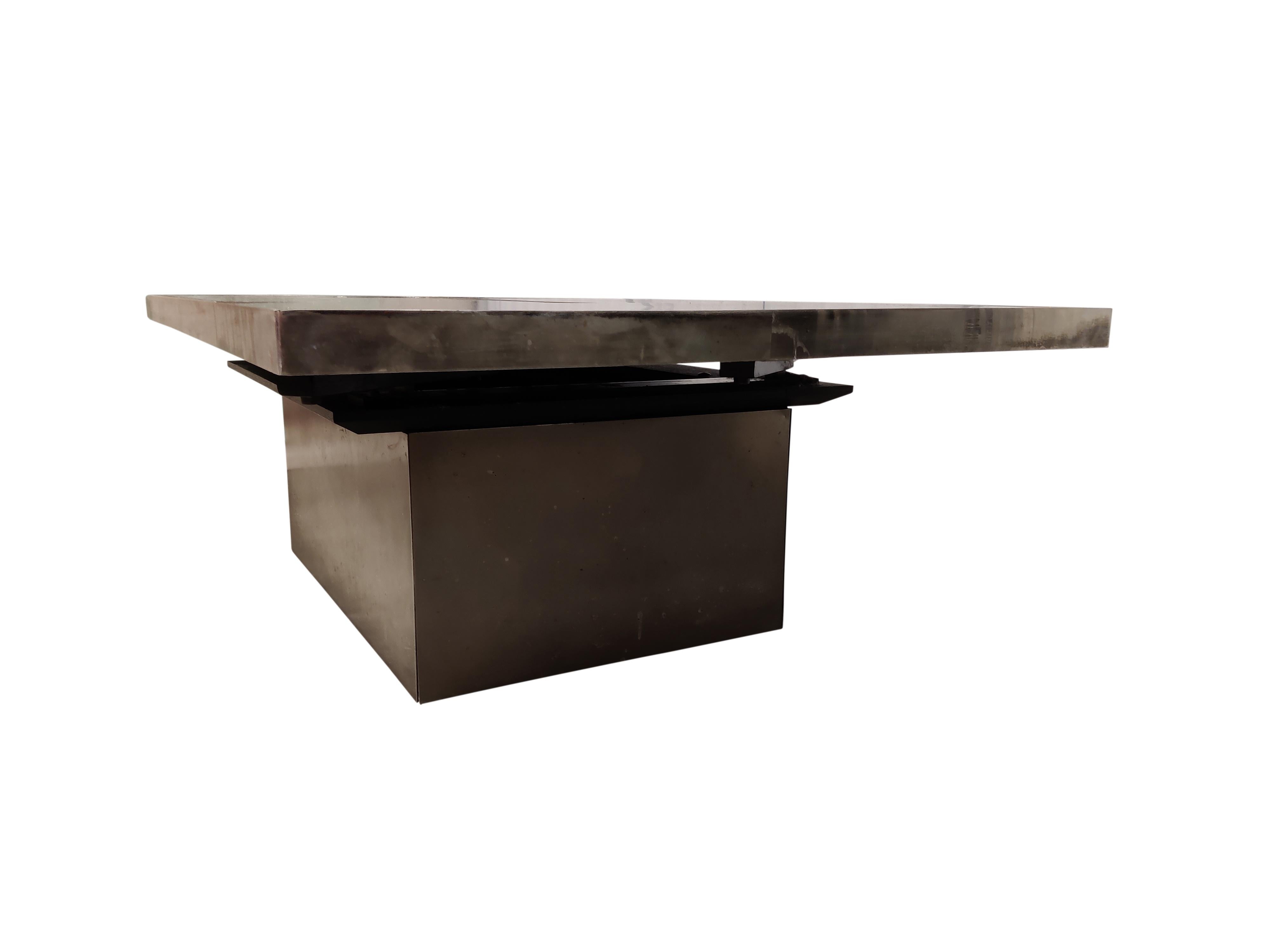 Hidden bar coffee table by Willy Rizzo.

This coffee table consists of two brushed steel pivoting parts that open up to showcase a mirrored bar compartment.

Condition: Used with some staining on the top but still offers a nice vintage feel. -