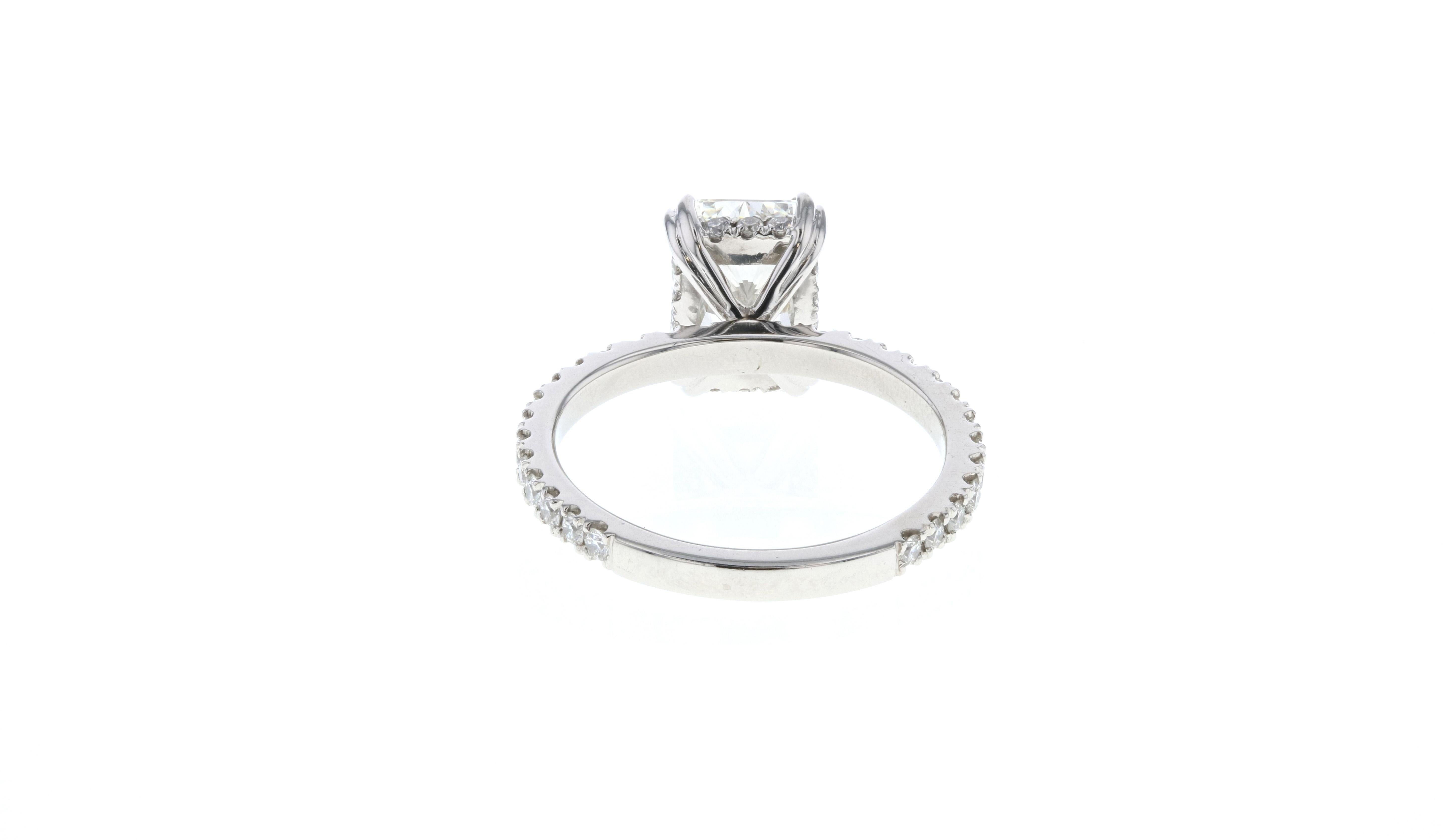 This diamond ring is crafted in platinum, & contains a Radiant shape Diamond (2.01 total carat weight, I color, SI1 clarity), surrounded by 42 round diamonds (0.42 total carat weight, I color, SI clarity).

A hidden halo is the perfect type of