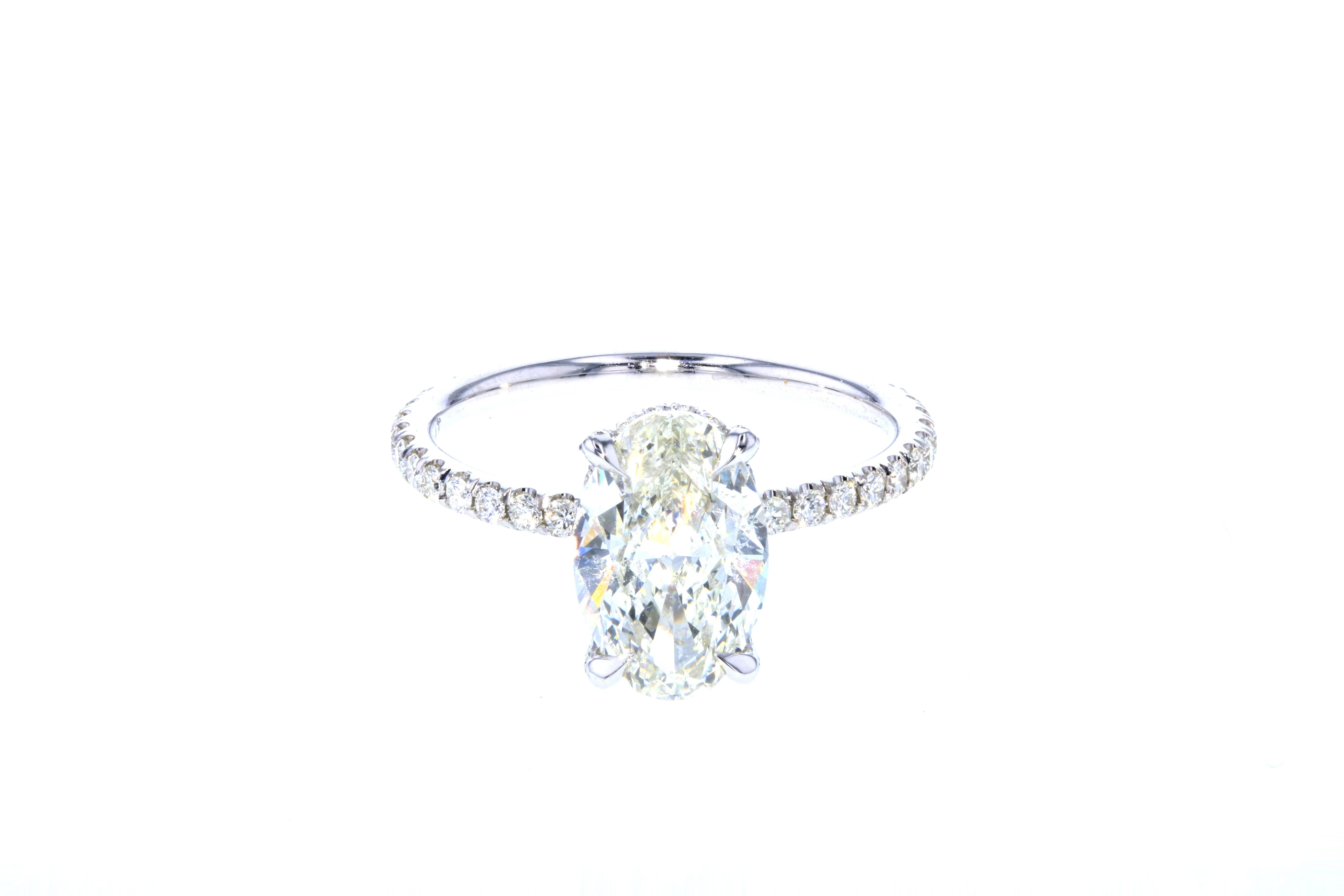 This diamond ring is crafted in platinum, contains an Oval Cut Diamond (2.03 total carat weight, I color, SI1 clarity) surrounded by 66 Round Brilliant Cut Diamonds (0.48 total carat weight, I color, VS clarity).

A hidden halo is the perfect type