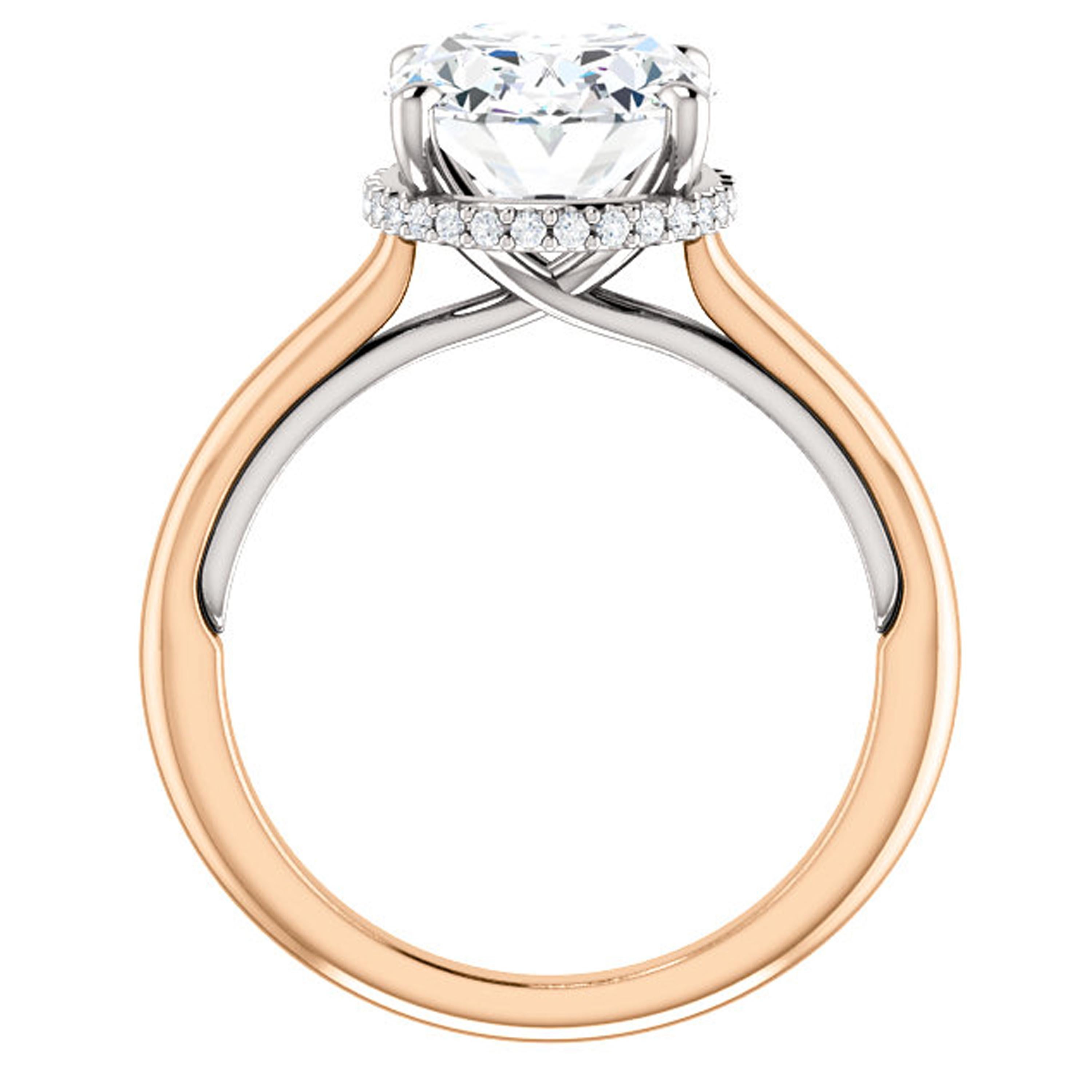 This plain shank engagement ring showcases a surprise halo visible through the gallery lined with shimmering diamonds. The breathtaking outline is amplified with an oval cut Forever One certified moissanite. This beautiful ring is handcrafted and