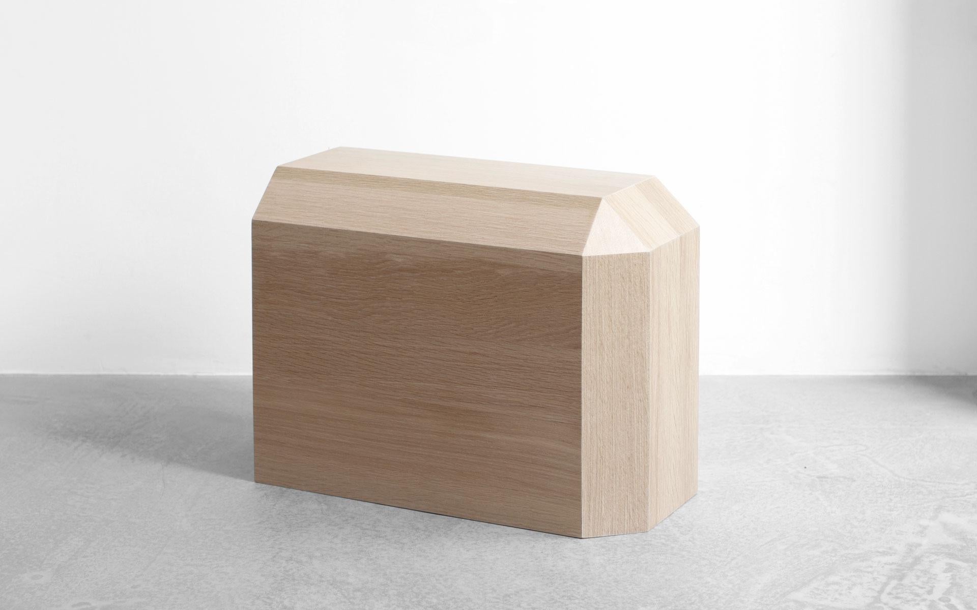 hiddenSkin is a stool and a side table in natural oak (mat finish). 
This piece has three other variations : whitened Douglas pine (sanded finish), natural oak (mat finish) with black leather and black tinted oak (satin finished) with black