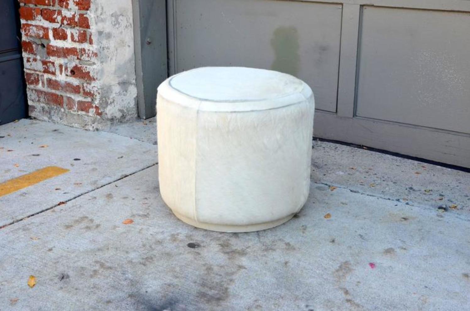 Hide covered cylinder ottoman stool.
