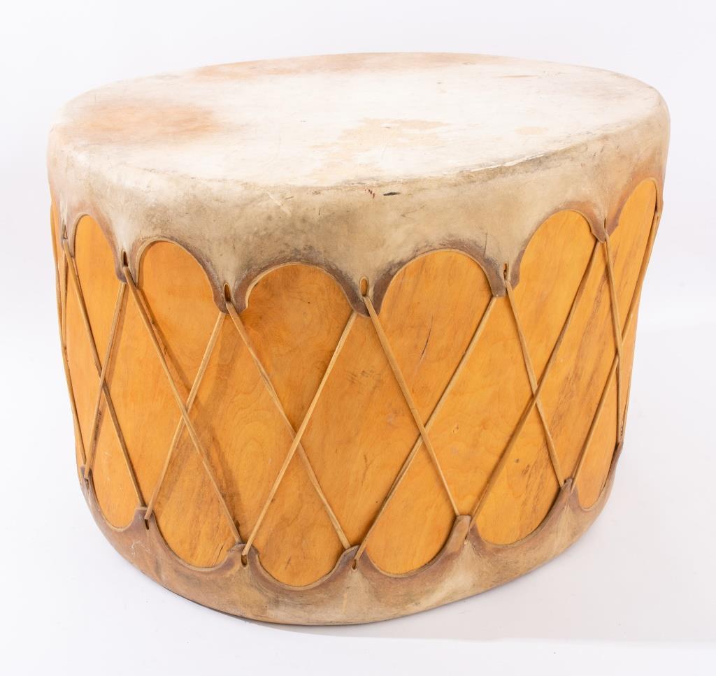 Hide-covered modern drum, possibly first peoples, 20th c. of shaped circular form, with hide stretched to top and bottom of a hollowed birch stump, with handles. 

Dealer: S138XX