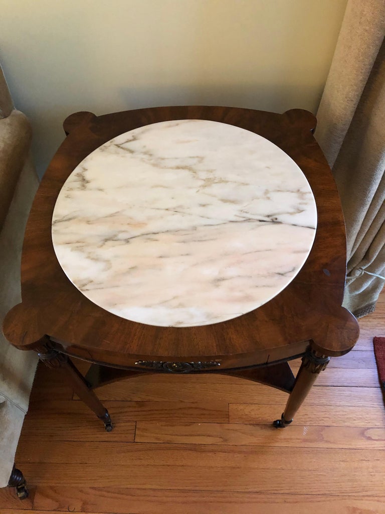 Vintage hand made bookmatched mahogany end table having lovely inset round white marble center that is 20