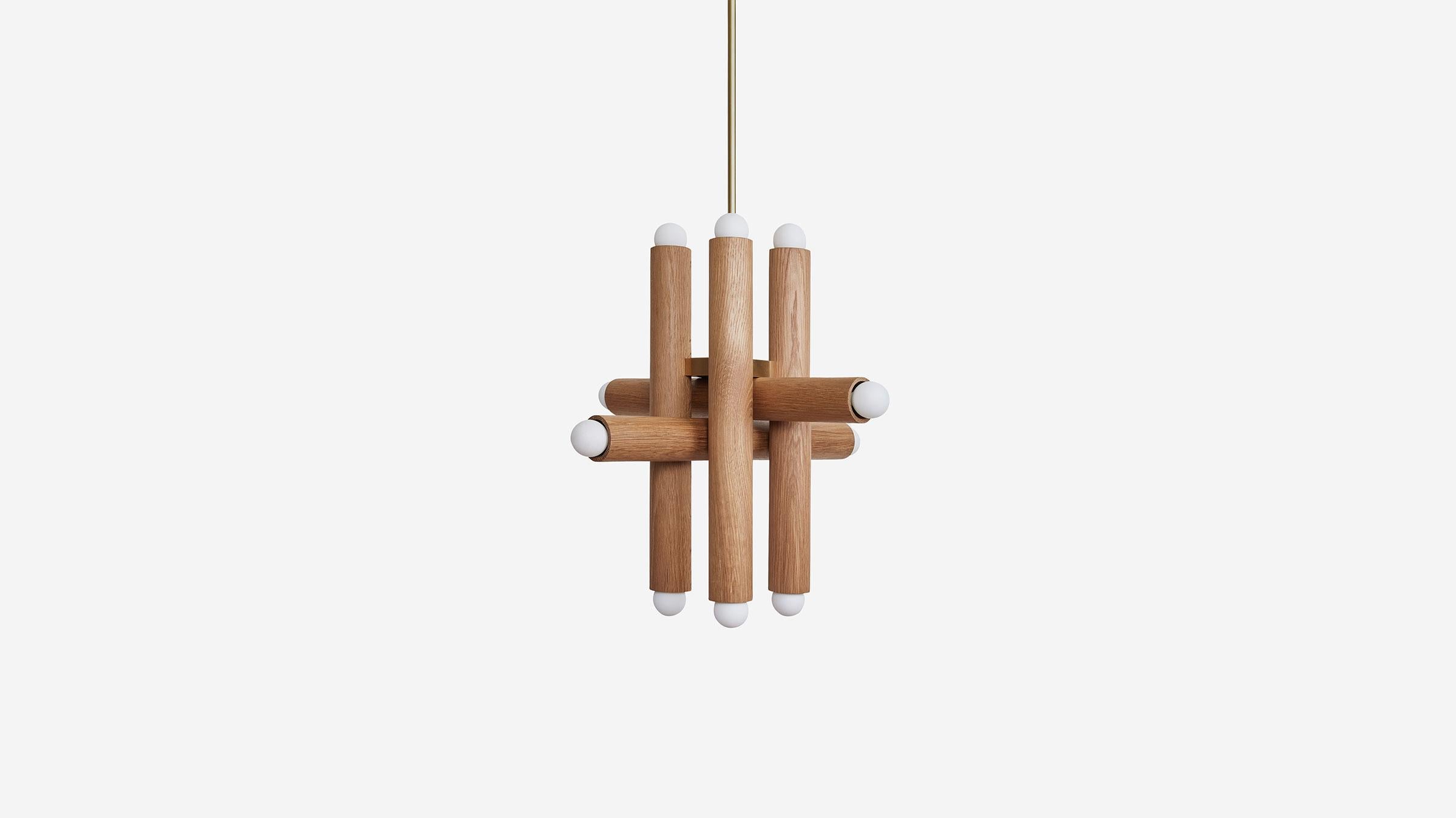 HIEROGLYPH PENDANT XII expands into a thicket of wooden canisters casting light in all directions. The physicality of both the density and luminosity of the fixture is countered by a delicate metal rod, allowing the fixture to effortlessly branch