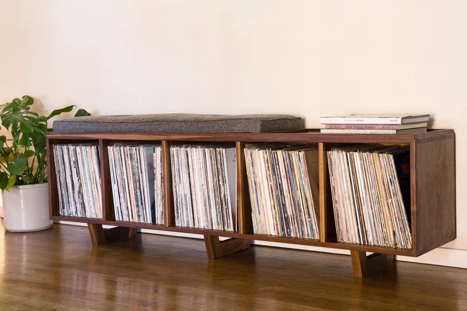 This bench is the ideal solution to having records sitting all over your house and no place to sit. This is an original design, but with a strong influence of Mid Century Danish Modern. The bench is roughly 67