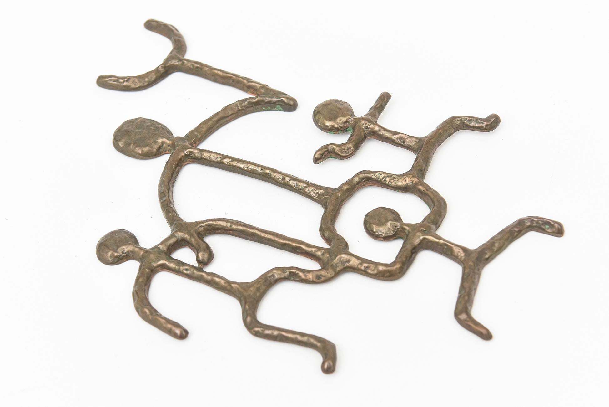 This most unusual work of art from the studio of Michael and Francis Higgins is a hand hammered bronze small stick figure wall sculpture. It is signed Higgins and from the 60's.
It is rare and obscure. One can frame it, use it on the wall as is or