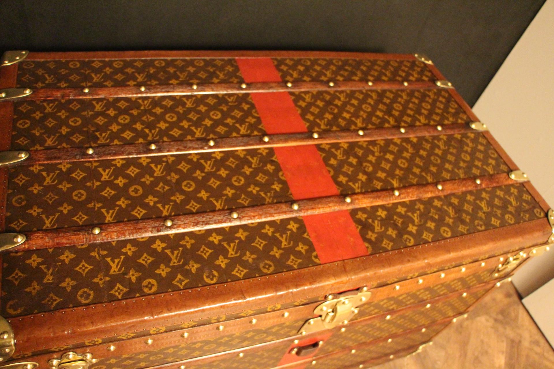 This superb Louis Vuitton steamer trunk features stenciled monogram canvas,honey color lozine trim, LV stamped solid brass locks and studs as well as leather side handles and brass corners. Its customized painted French flag on its sides as well as